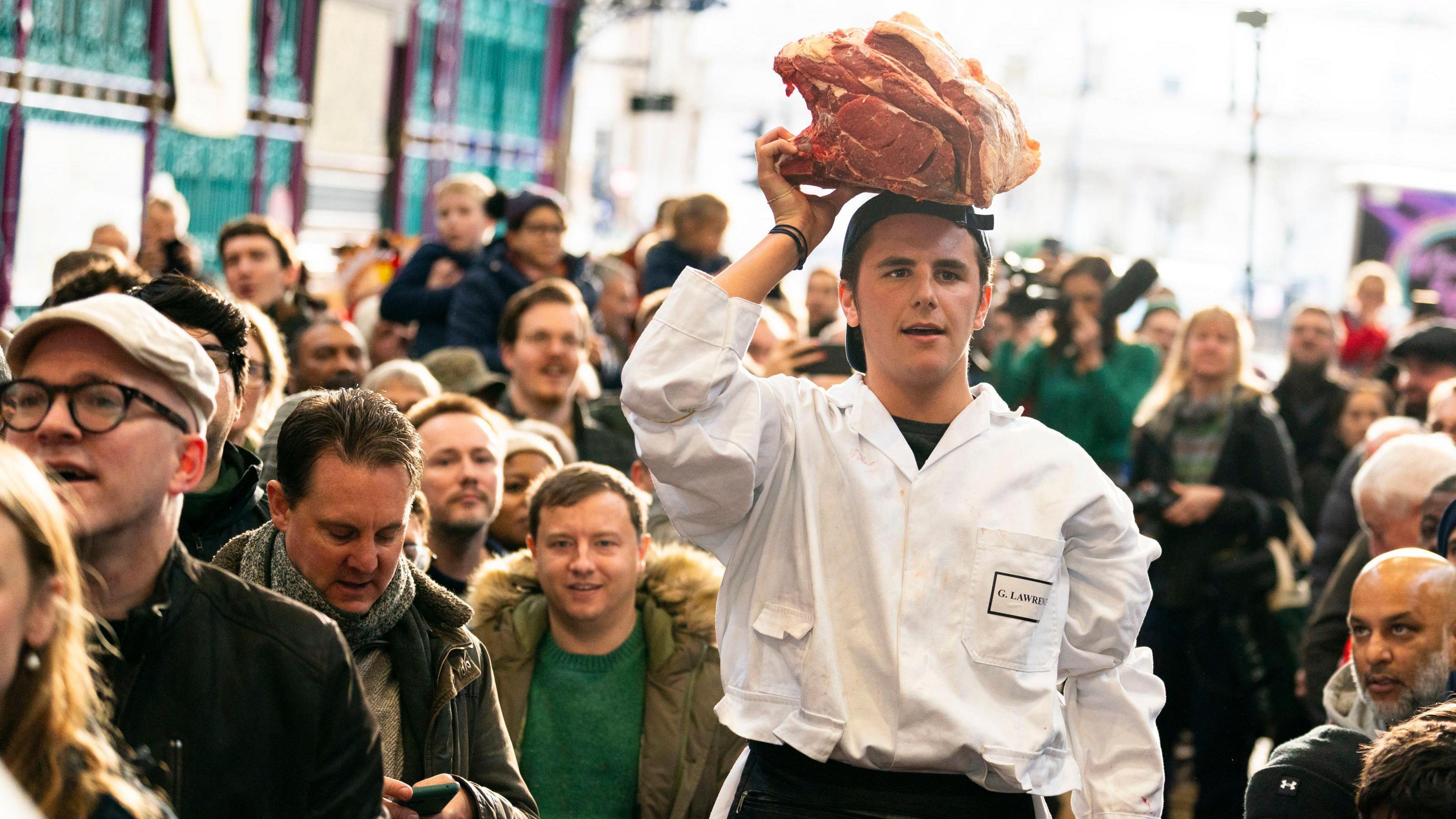 Seller with meat balanced on his head