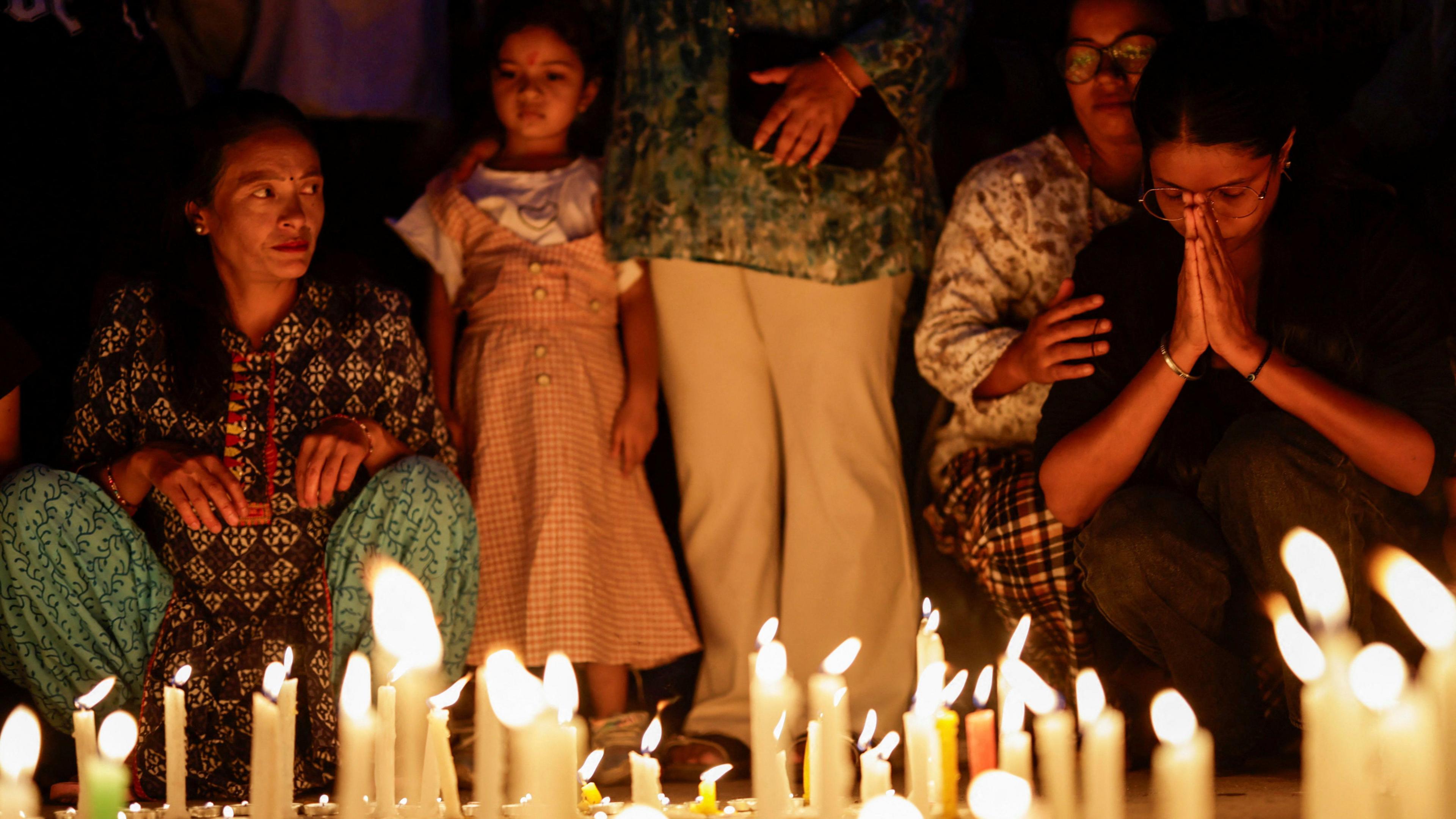 People take part in a candlelight vigil in memory of people who died during the protest against anti-corruption triggered by a social media ban 