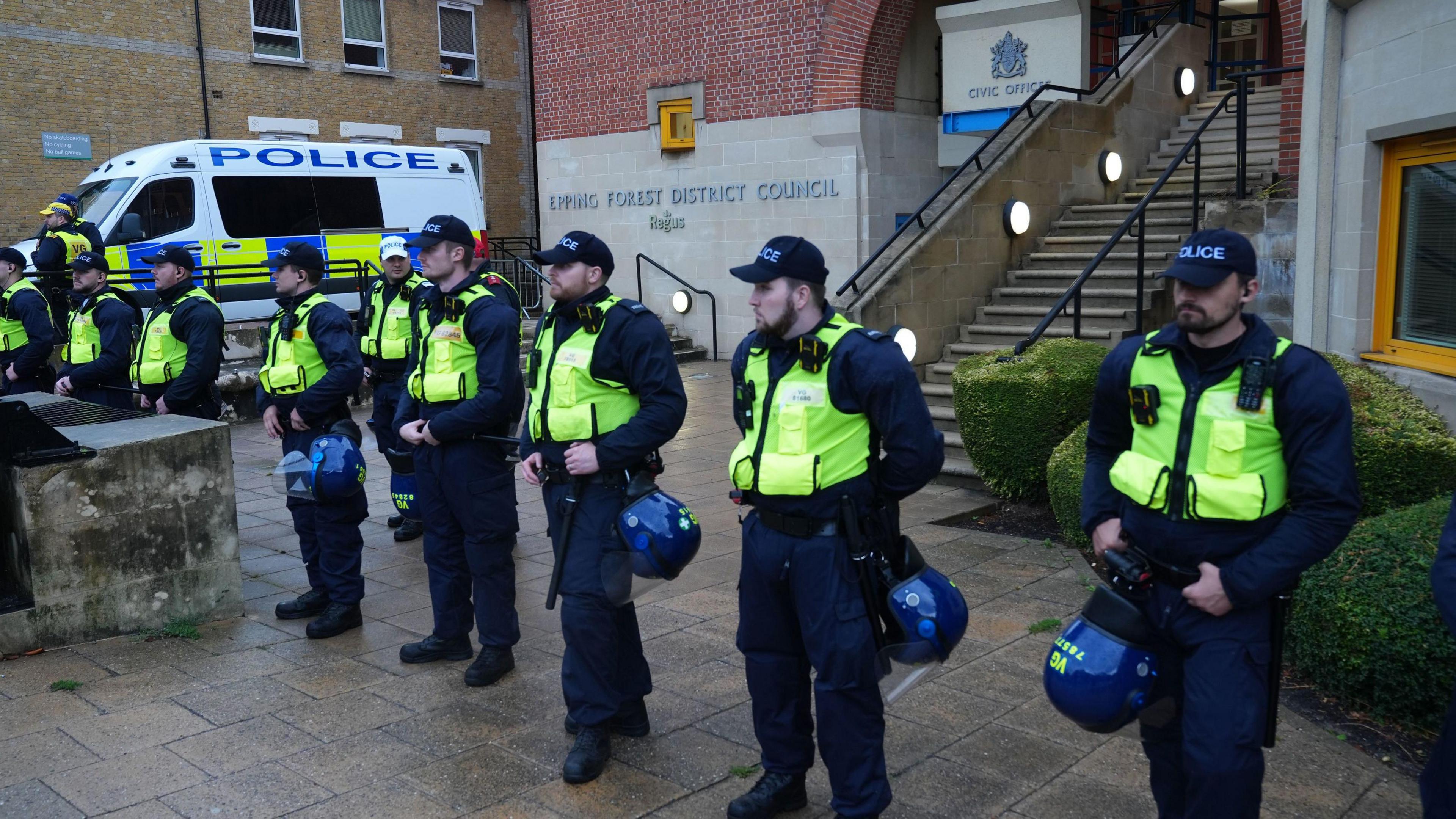 About 10 police officers are lined up outside the office for Epping Forest District Council