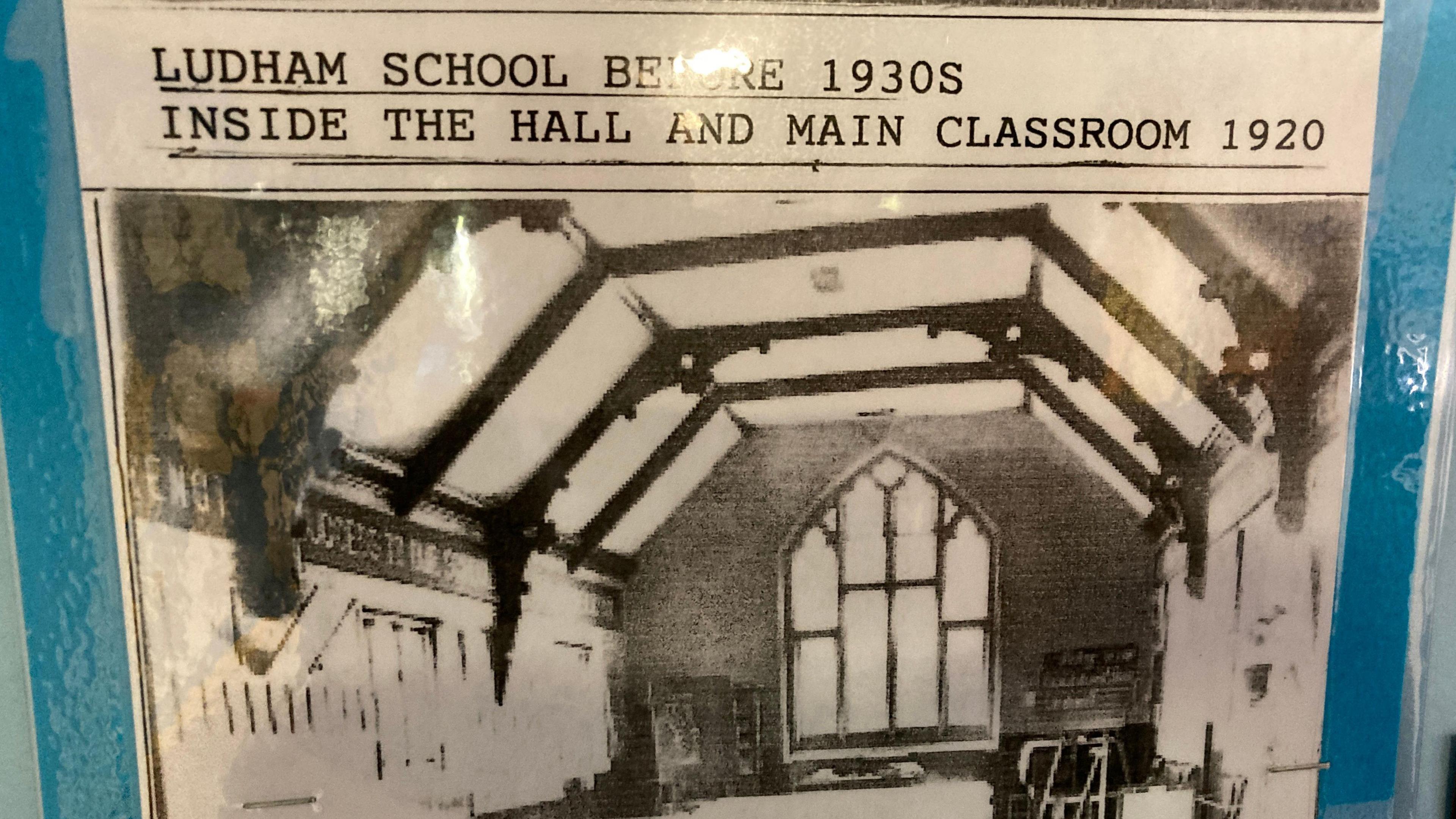 A print out on display at Ludham Primary School showing old roof beams in the main hall, taken in 1920