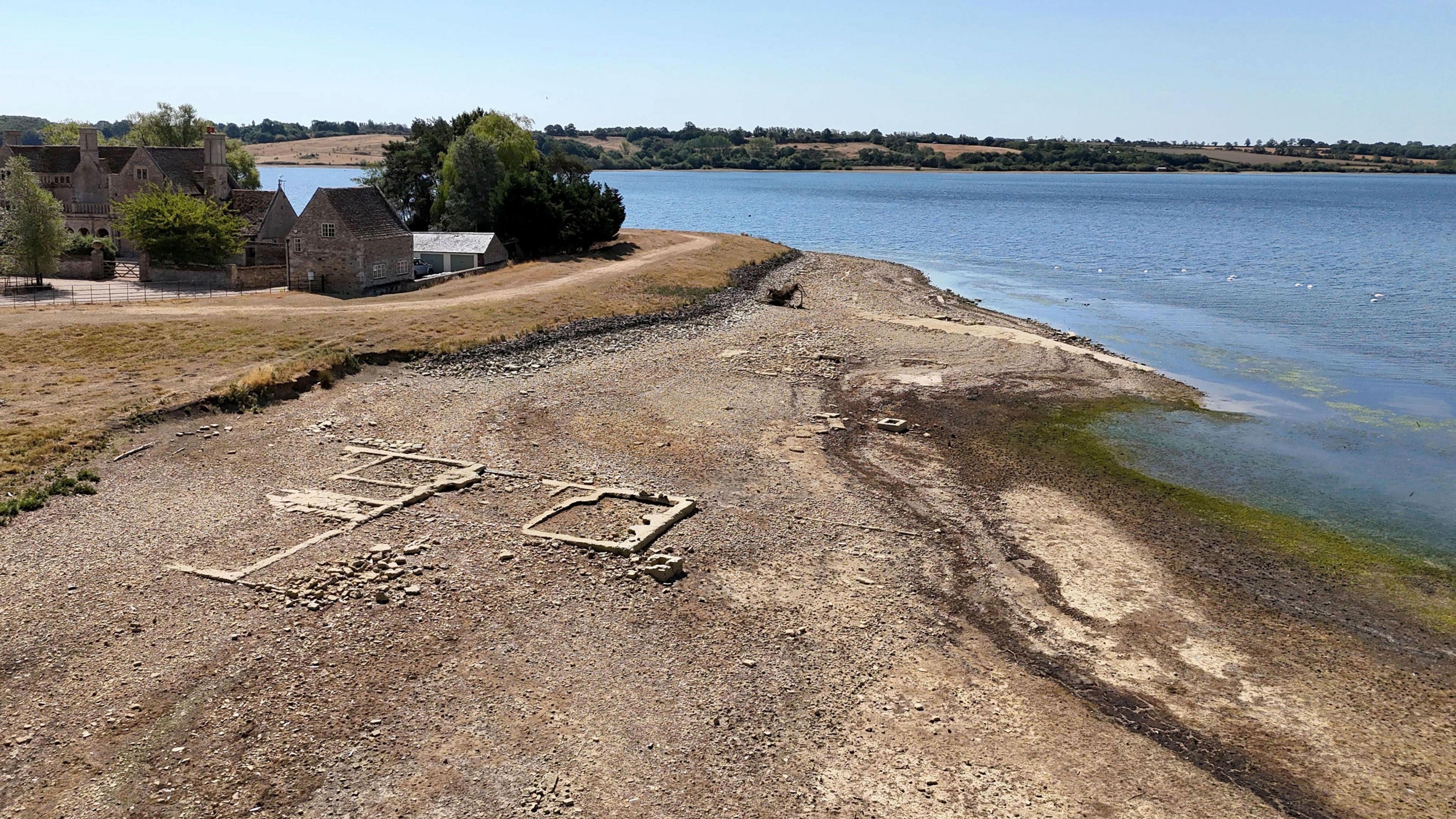 Stonework from the lost village of Nether Hambleton is revealed by the low water levels at Rutland Water reservoir in the East Midlands.