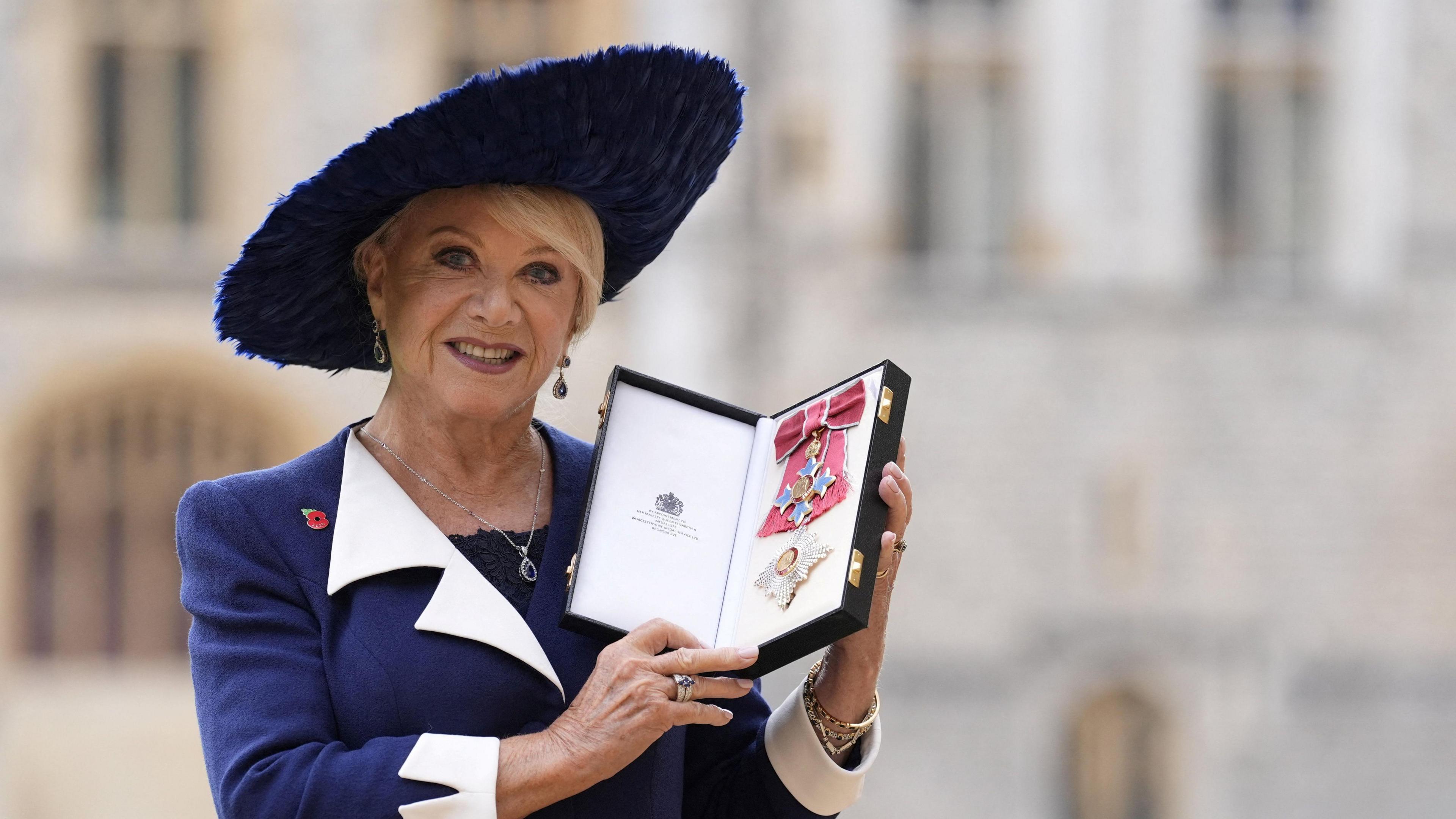 Dame Elaine in a blue and white suit pictured outside Windsor Castle
