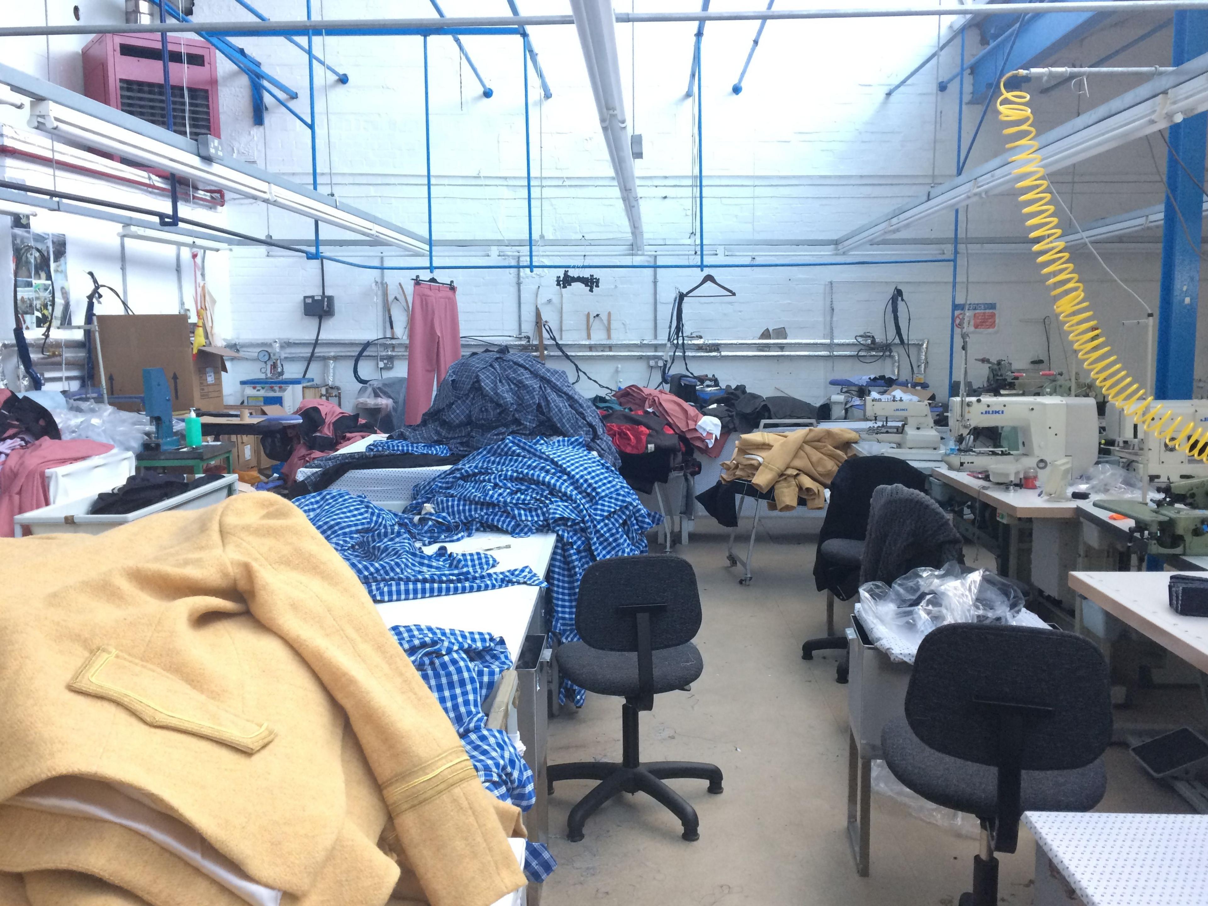 A textiles manufacturing workplace in London, where there are lots of visible materials to make clothes, along with sewing machines and other textiles-related machinery