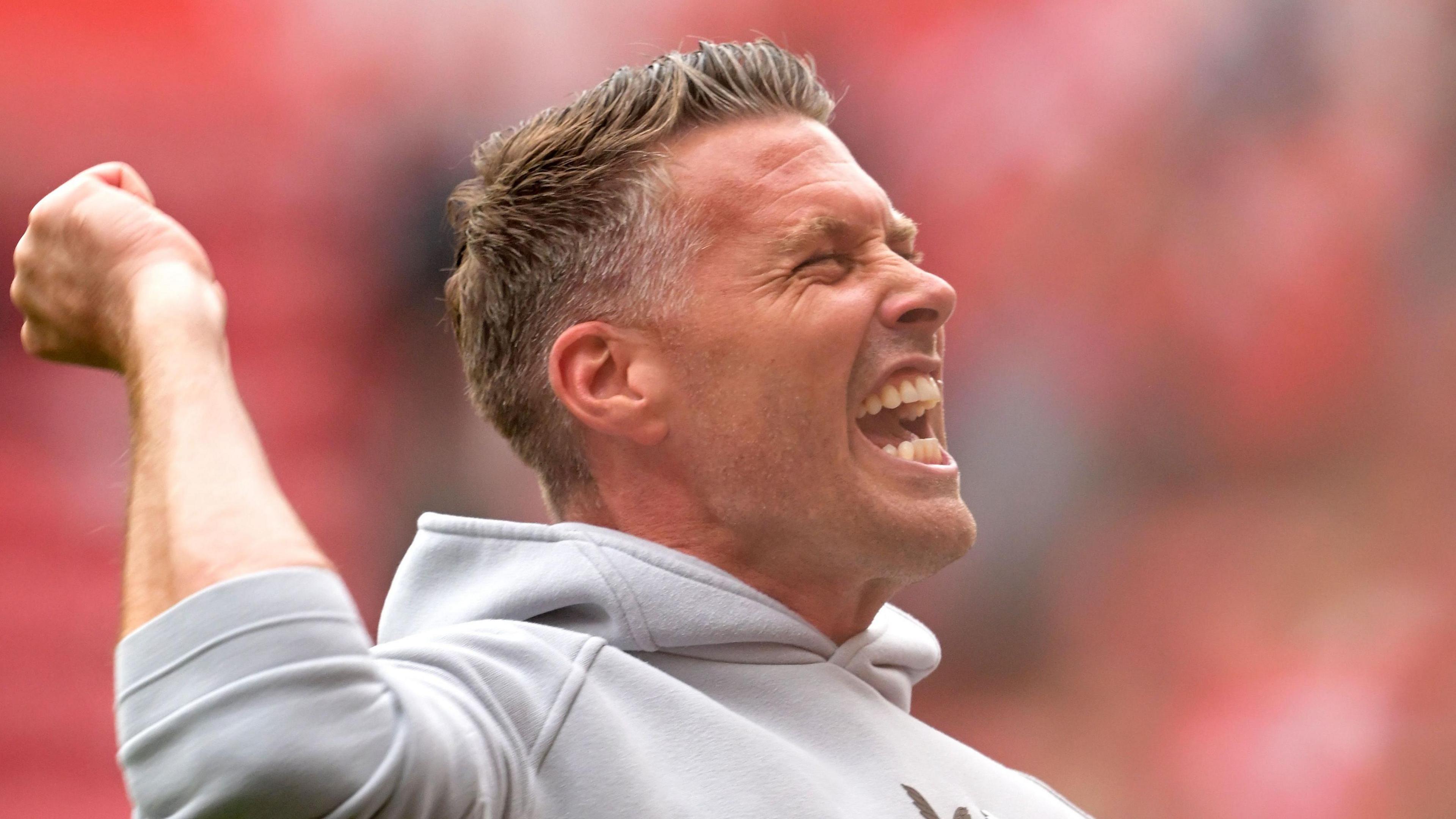 Rob Edwards punches the air in the direction of Middlesbrough fans after they beat Sheffield United