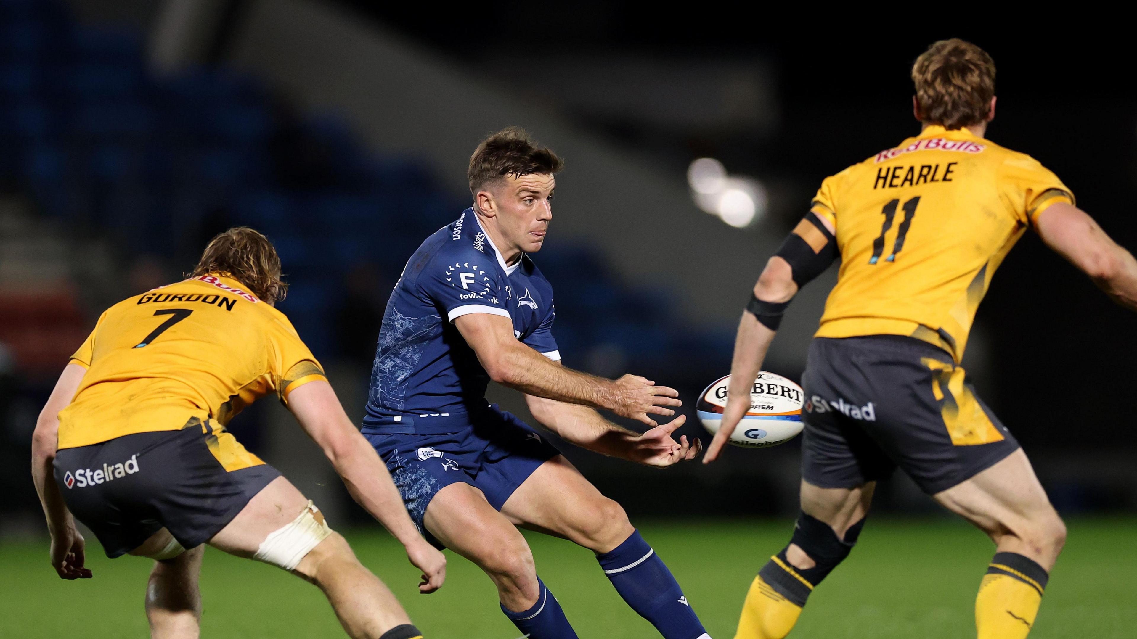 George Ford about to pass the ball for Sale Sharks as two Newcastle Red Bulls - Tom Gordon (7) and Alex Hearle (11) try to close him down