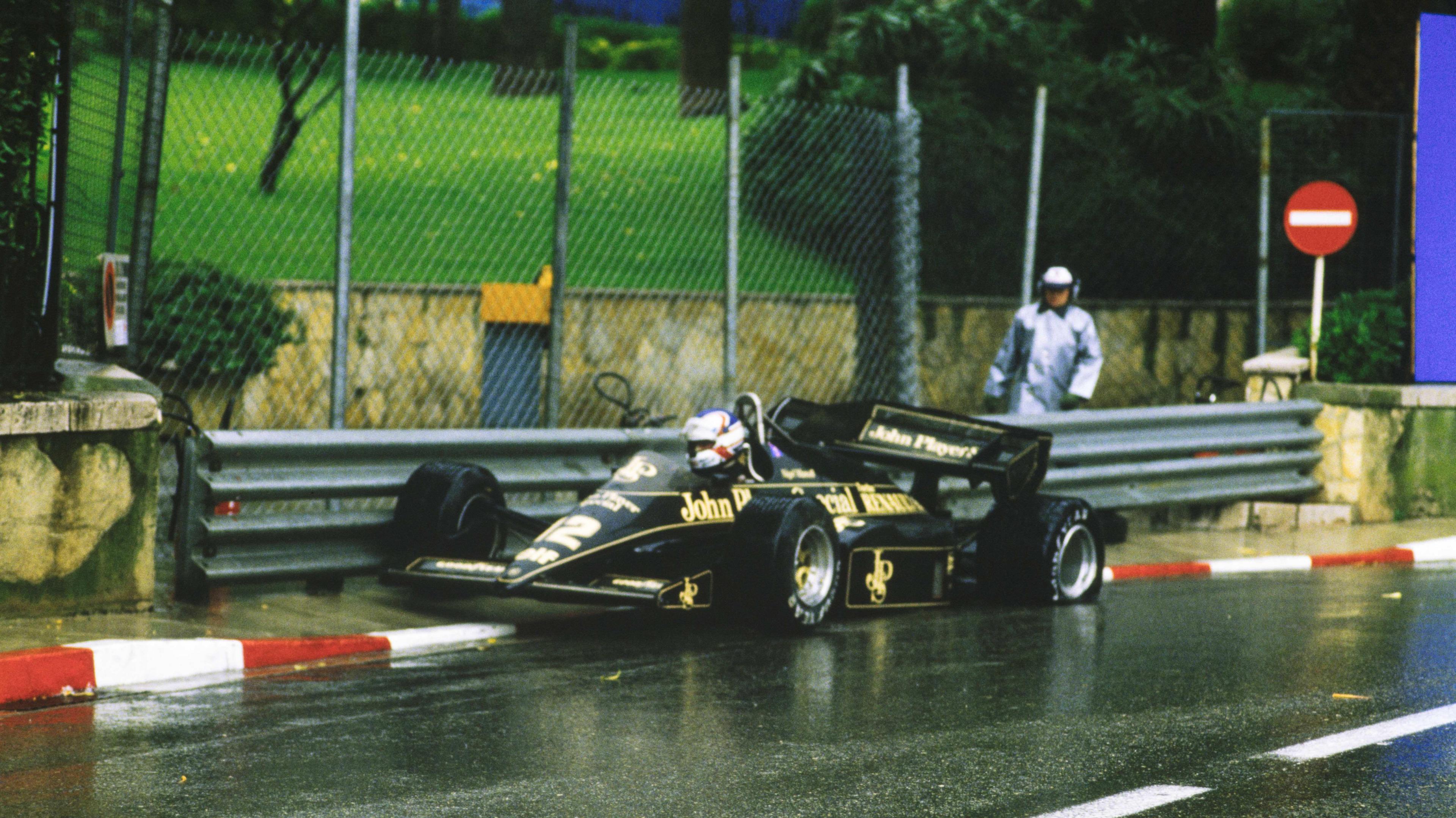 Nigel Mansell's Lotus parked up on the kerb, with a broken rear wing, after he crashed out of the lead in 1984