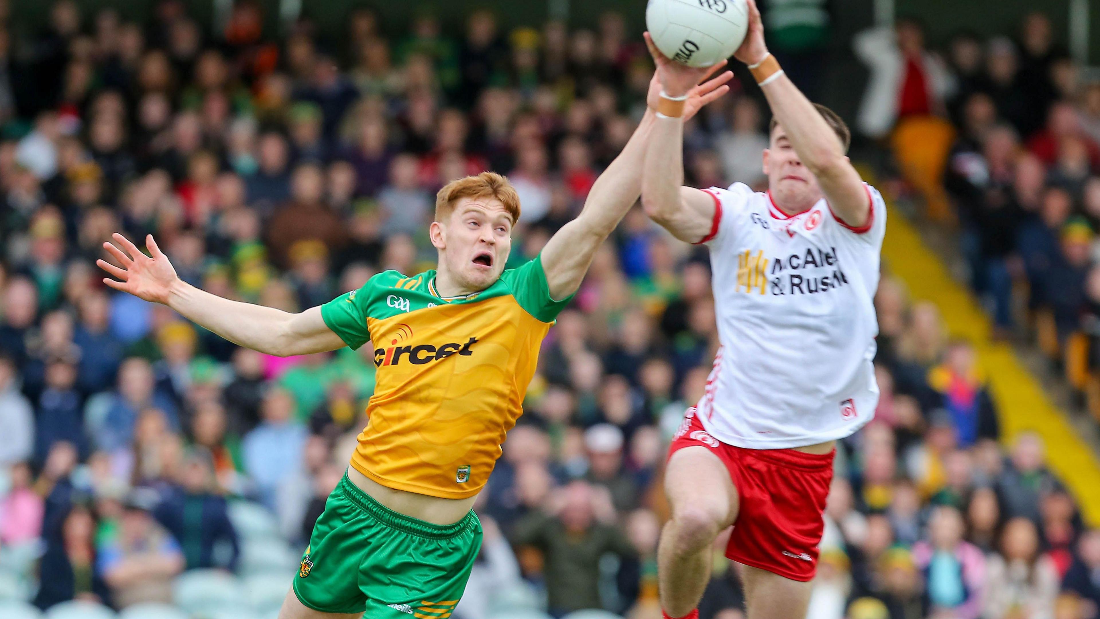 Tyrone's Niall Devlin stretches for the ball