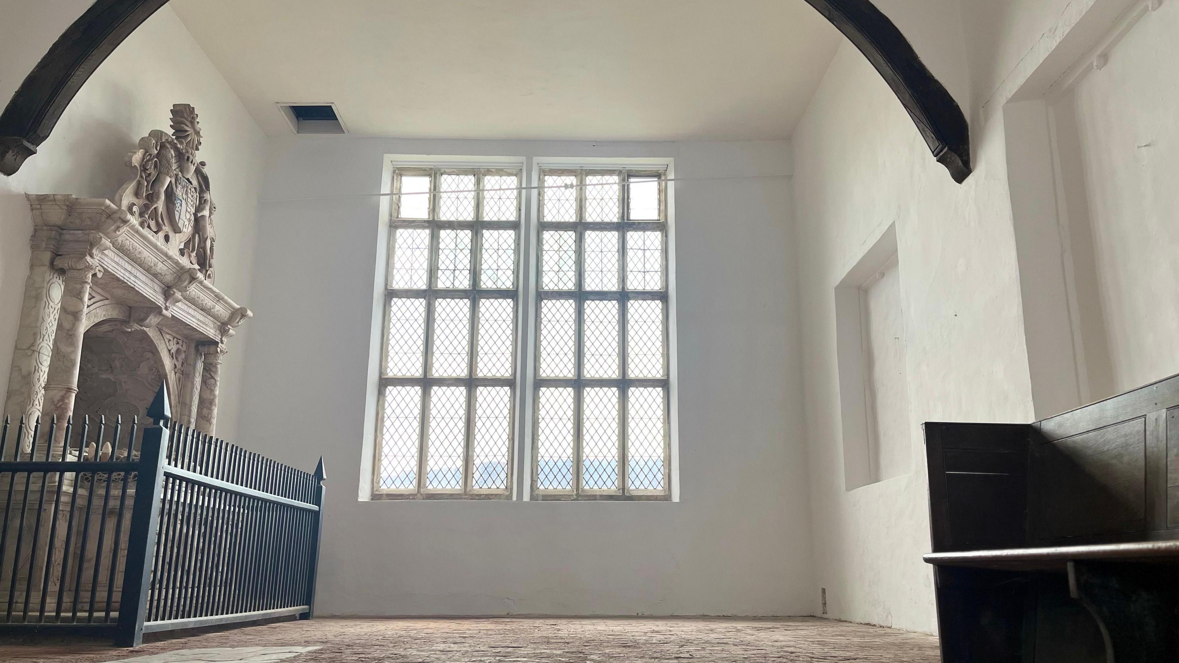 The refurbished chapel in Bradgate House, with a fireplace and a large window