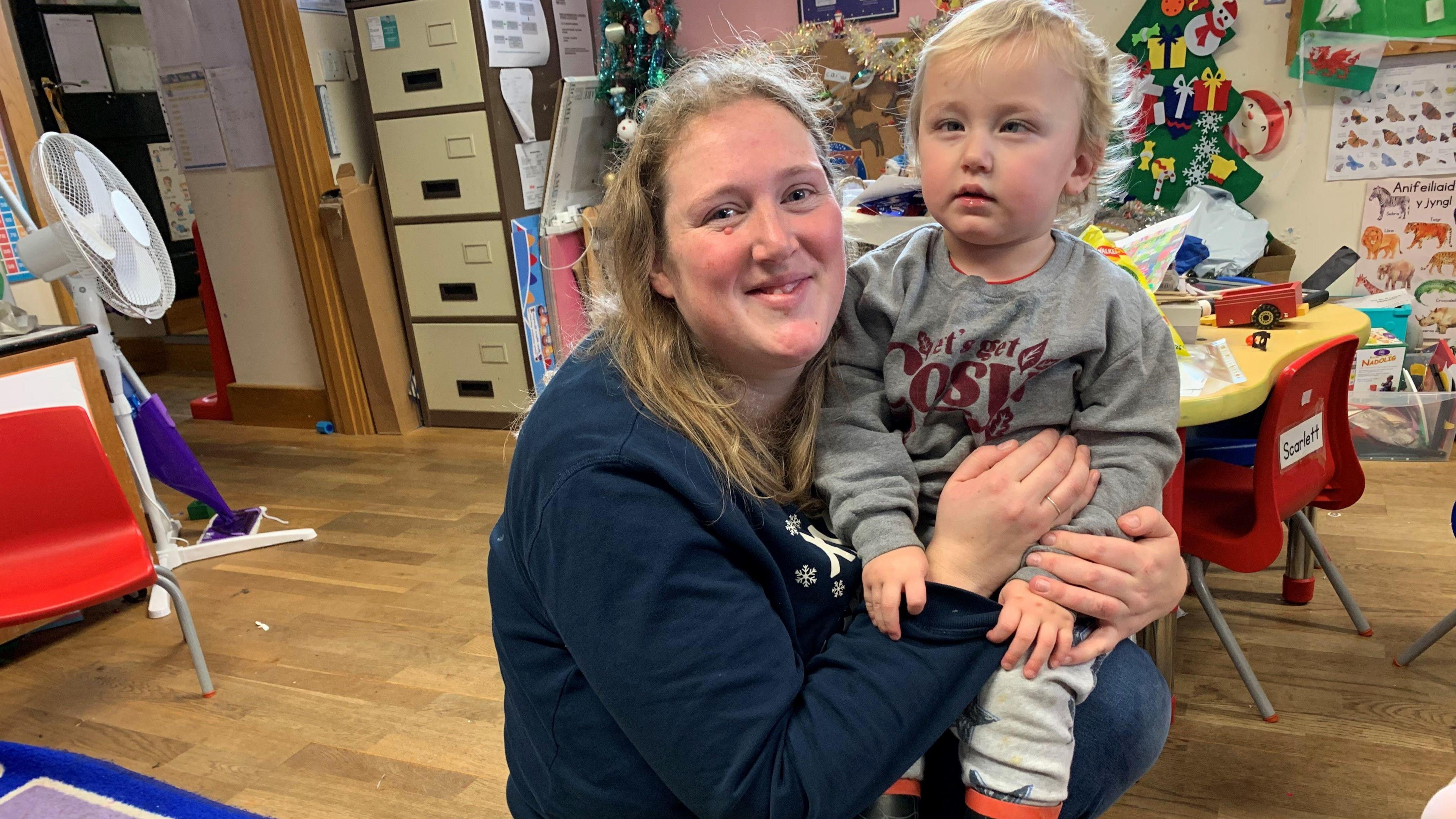 Emily at the nursery with her child