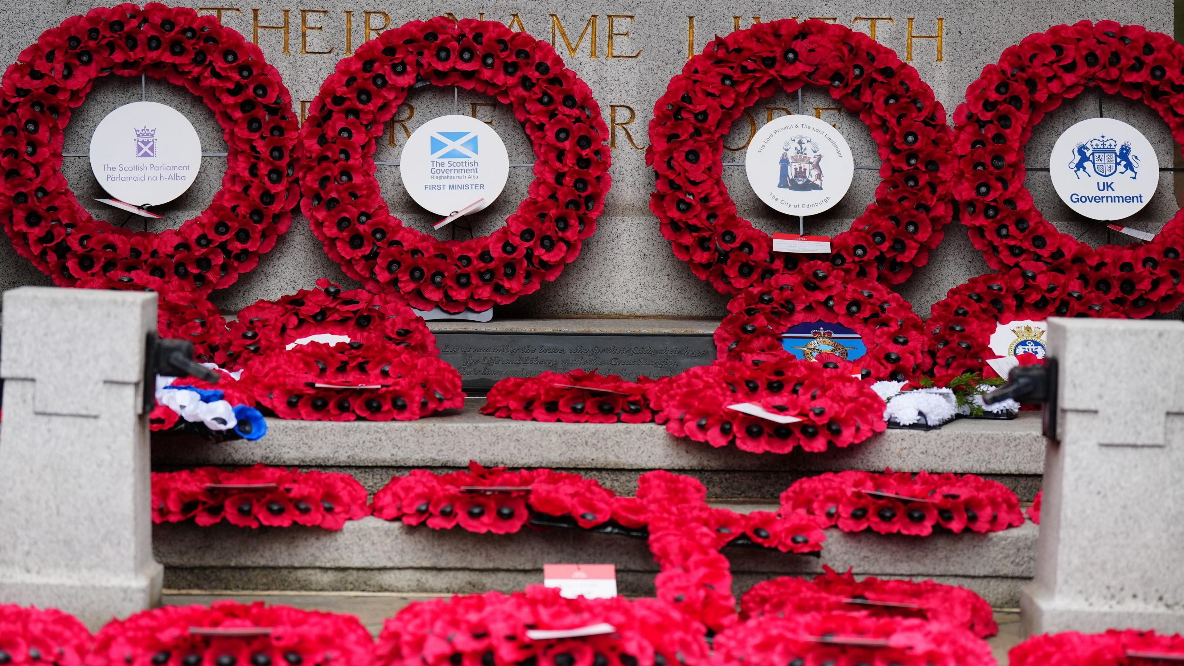 Red poppy wreaths laid at the Stone of Remembrance in Edinburgh.