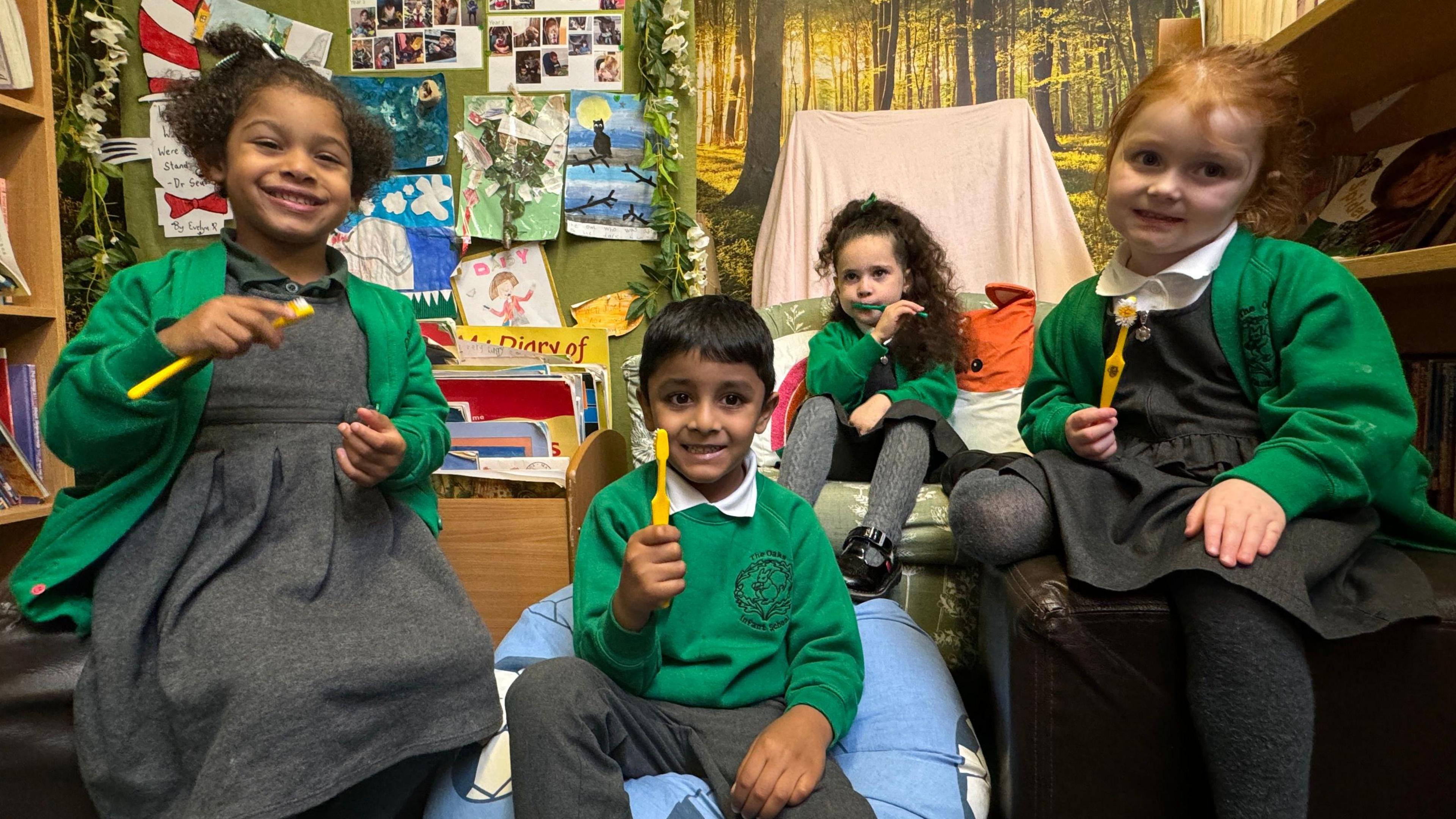 Pupils at The Oaks Infant School in Sittingbourne hold up their toothbrushes,  given to them as part of the schools supervised teeth brushing scheme