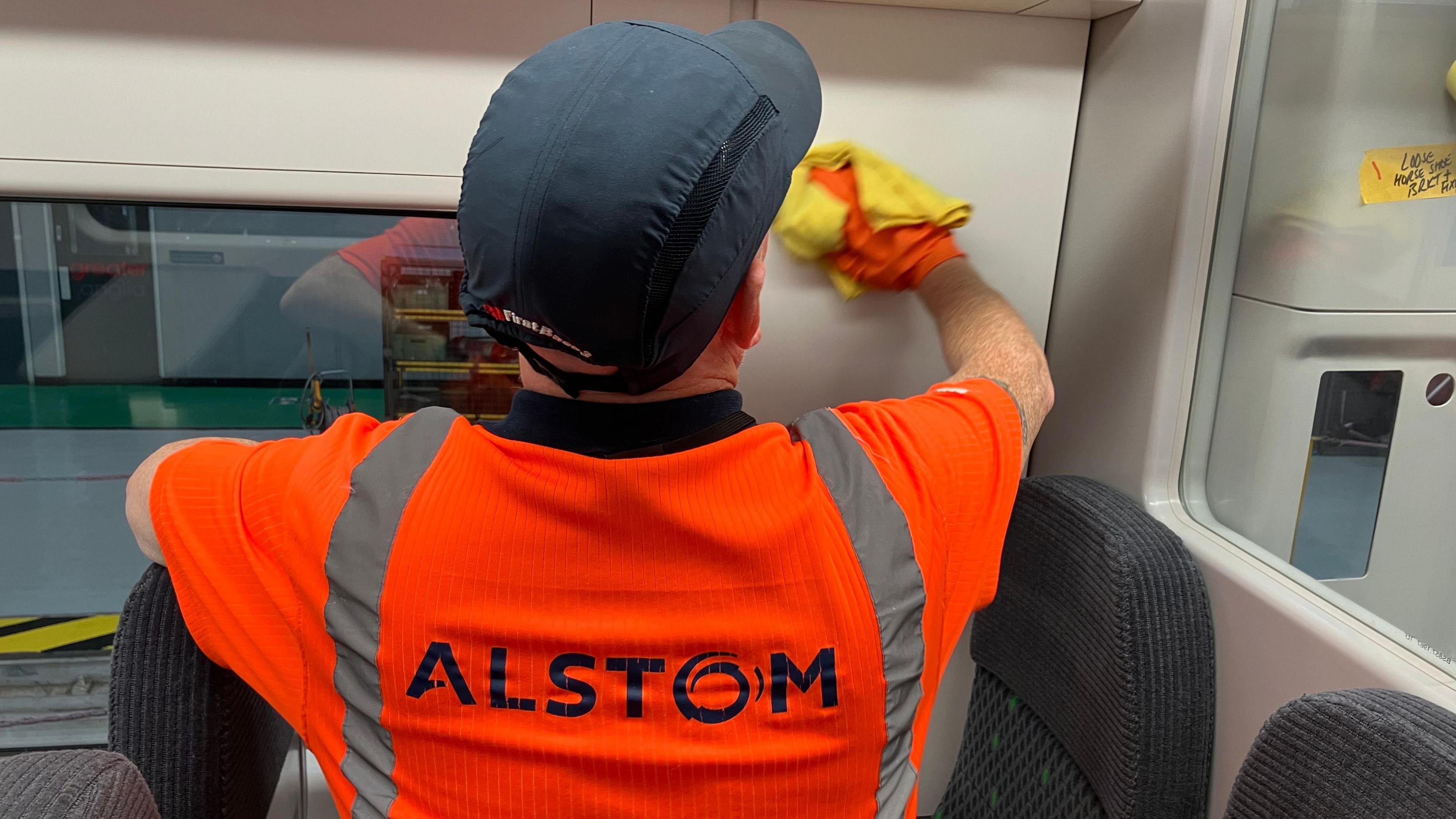 Alstom staff member working on the interior of a train 