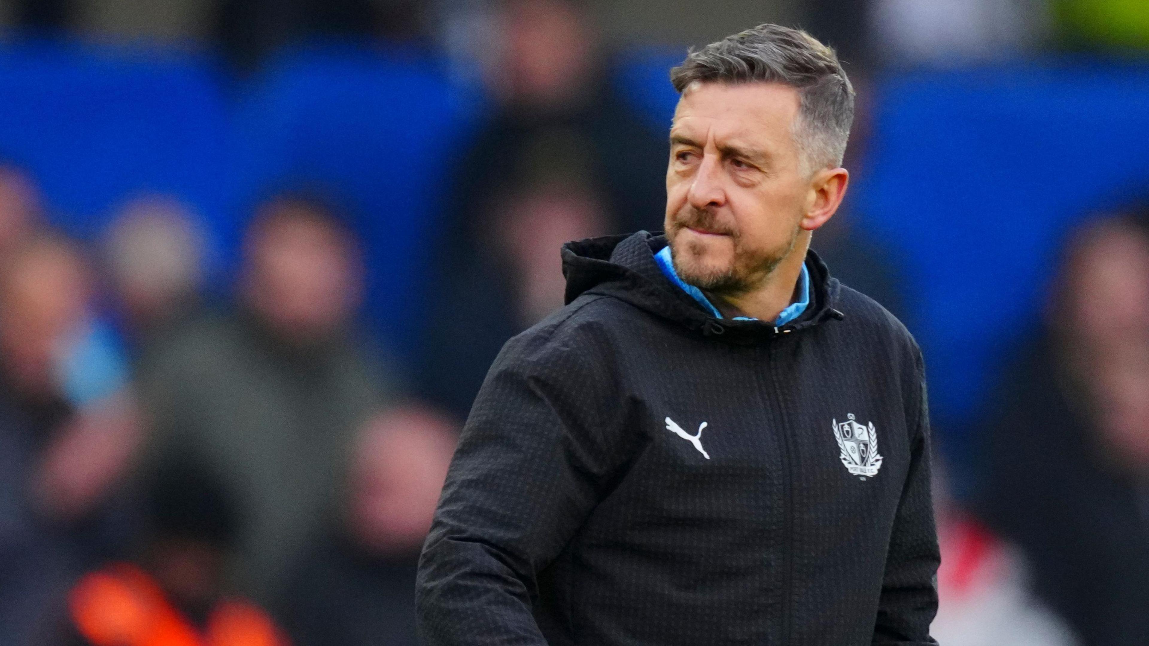 Jon Brady looks to his left as he walks off the field for half-time 