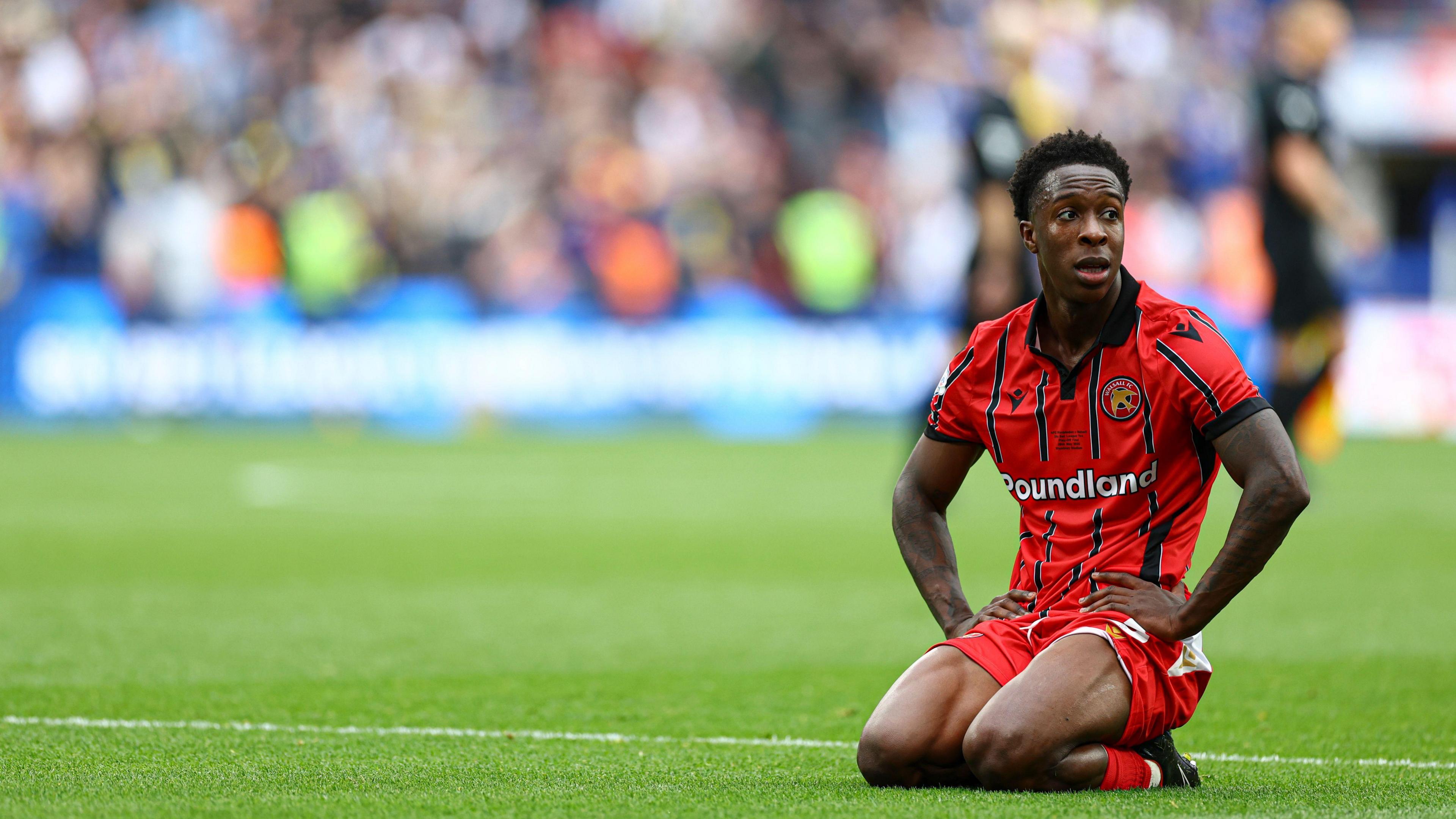 Walsall's Liam Gordon looks dejected kneeling down on the pitch after the final whistle at Wembley as his side lose the League Two play-off final.