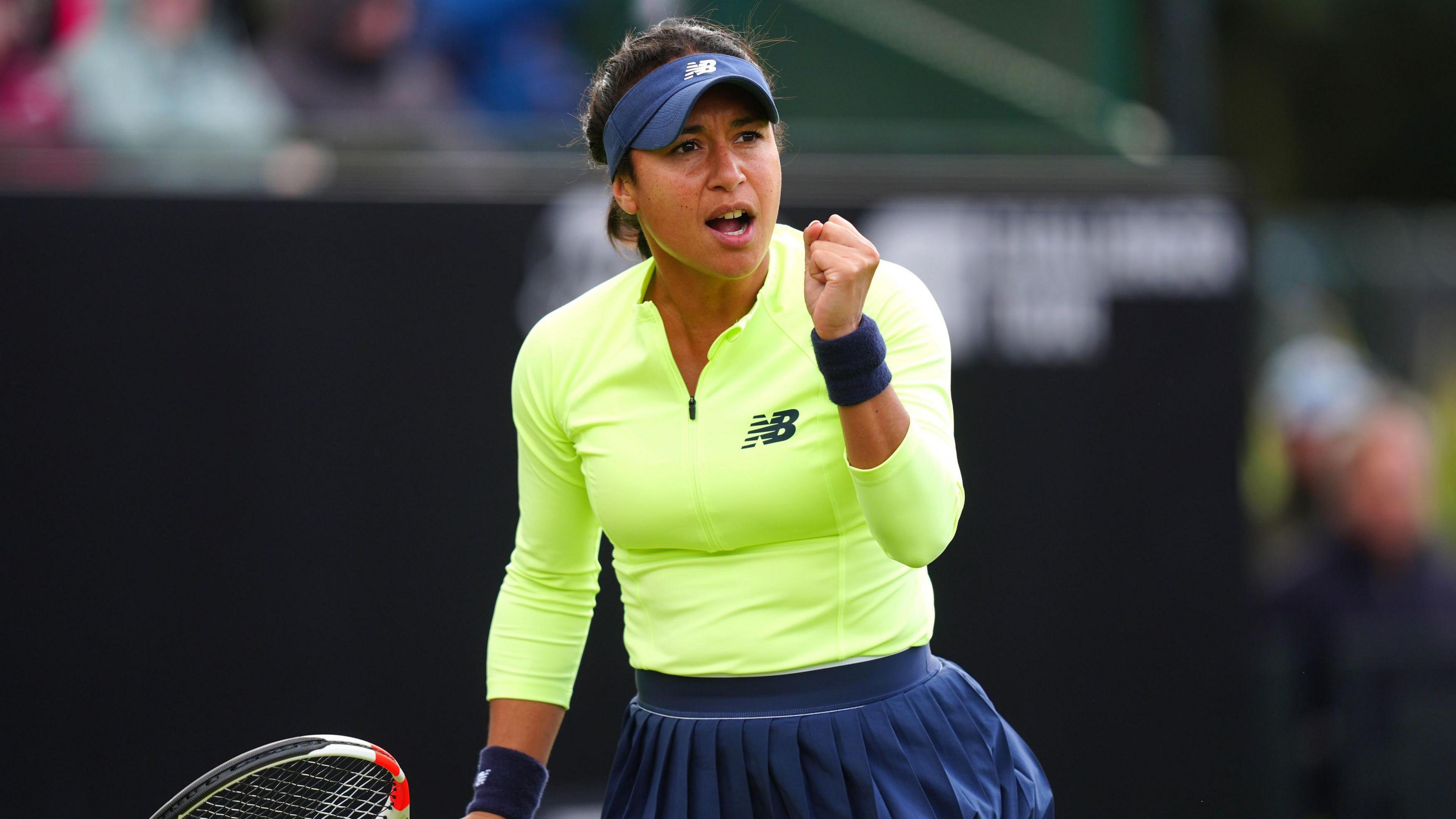 Heather Watson holds up her fist in celebration