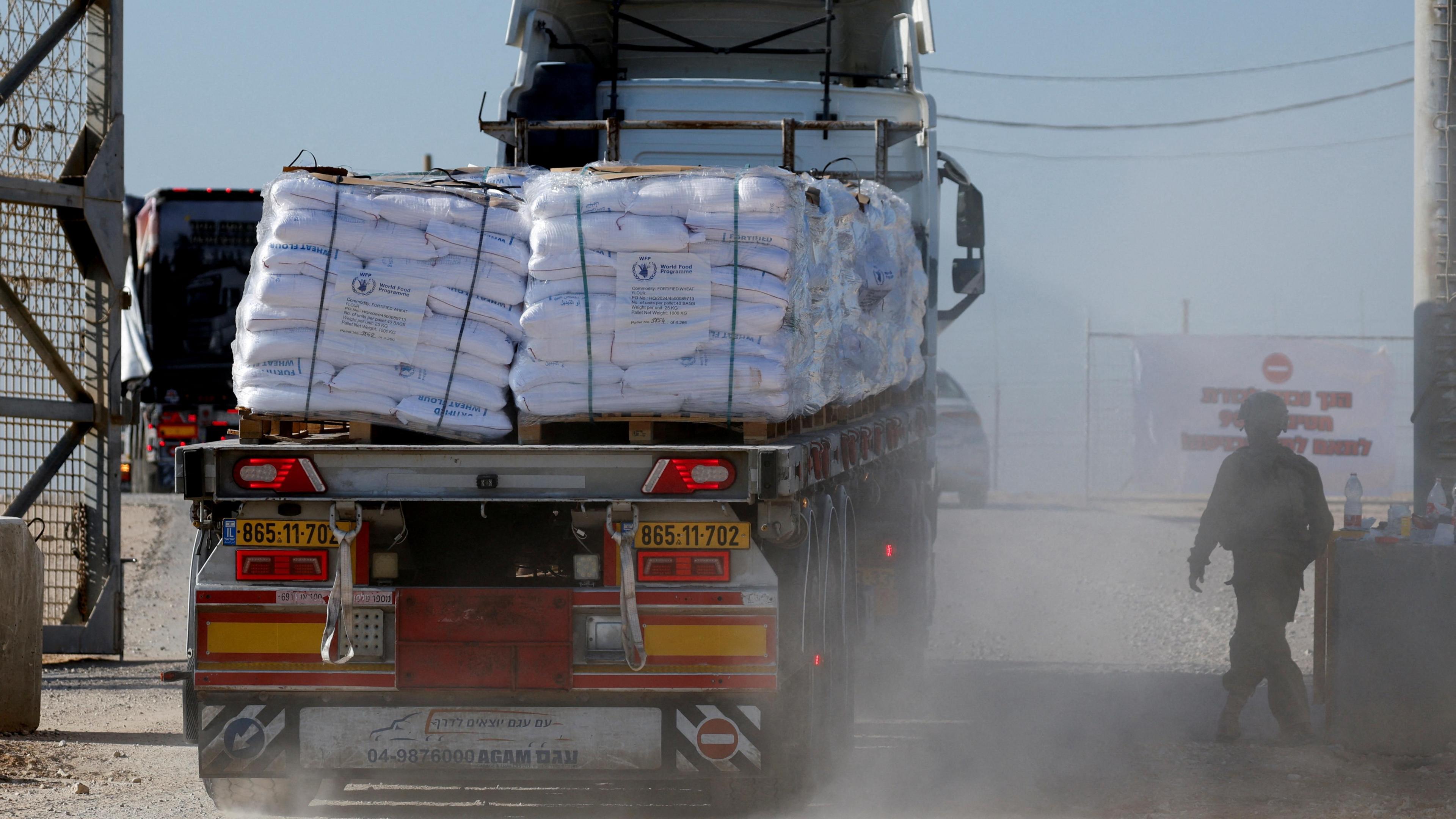 A lorry carrying humanitarian aid crosses into southern Gaza via the Israeli-controlled Kerem Shalom crossing in southern Israel (11 November 2024)