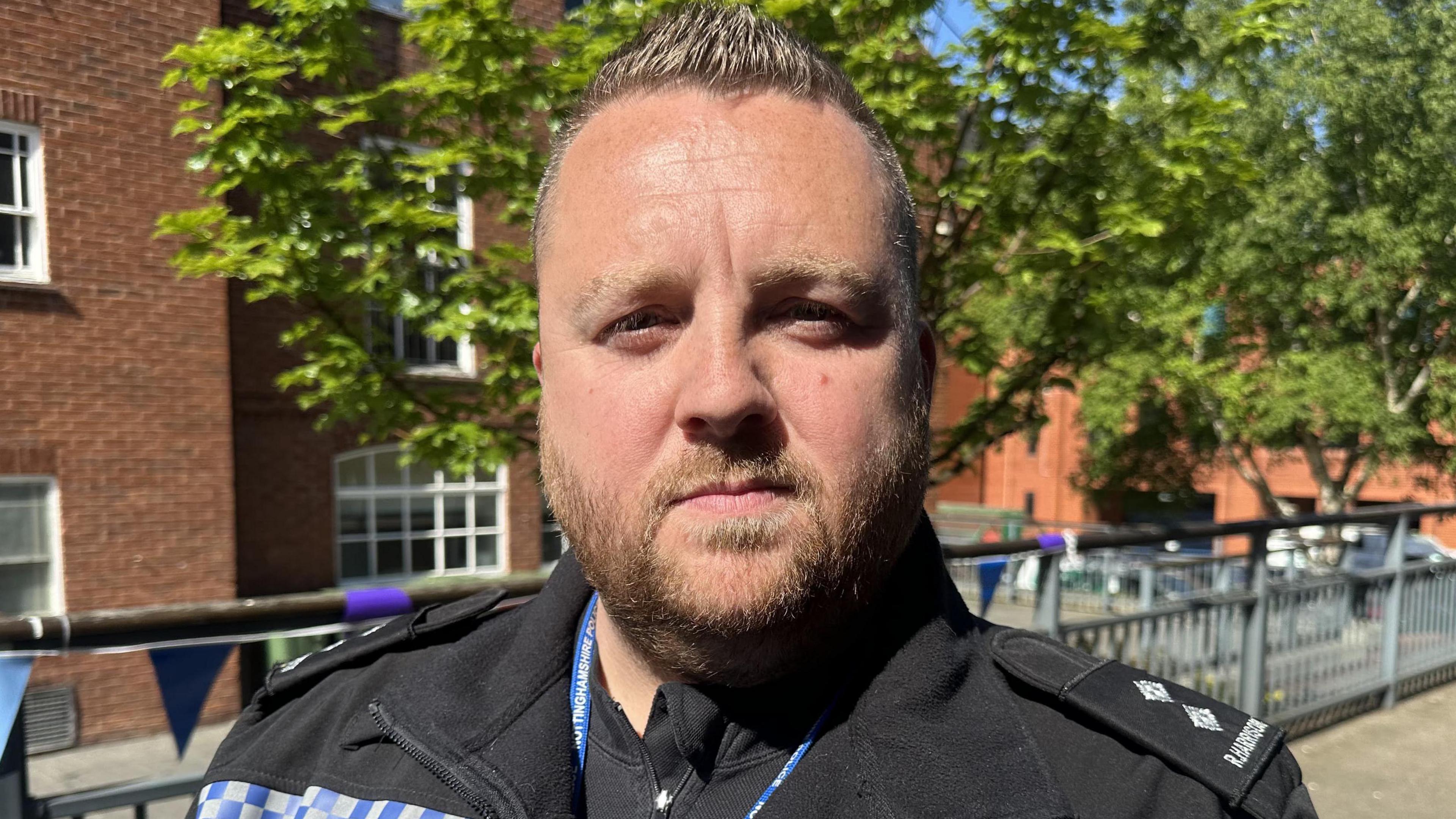 A policeman in uniform stood outside