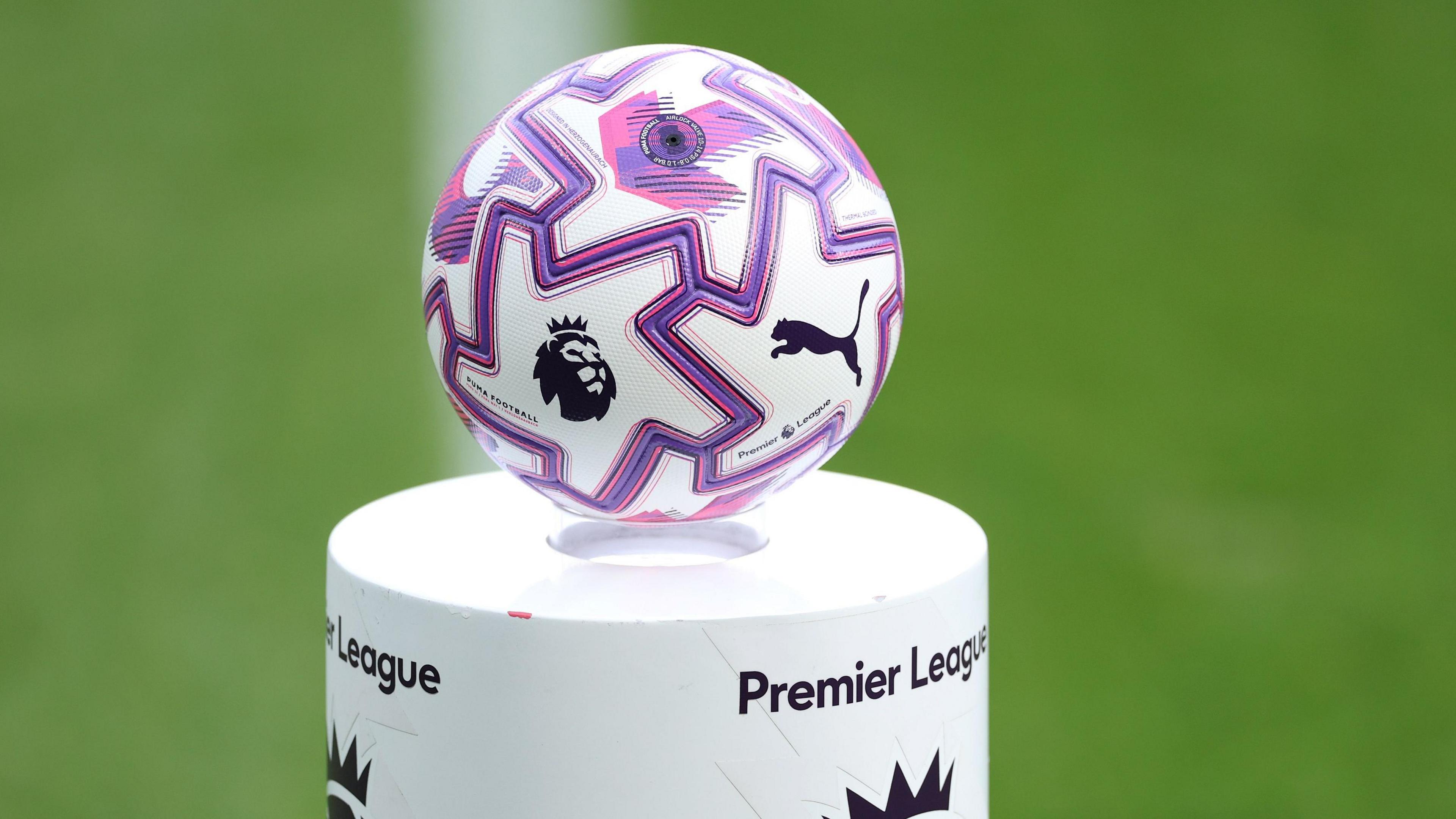 A Premier League ball sits on a pitchside plinth bearing the competition's name before kick-off at a match