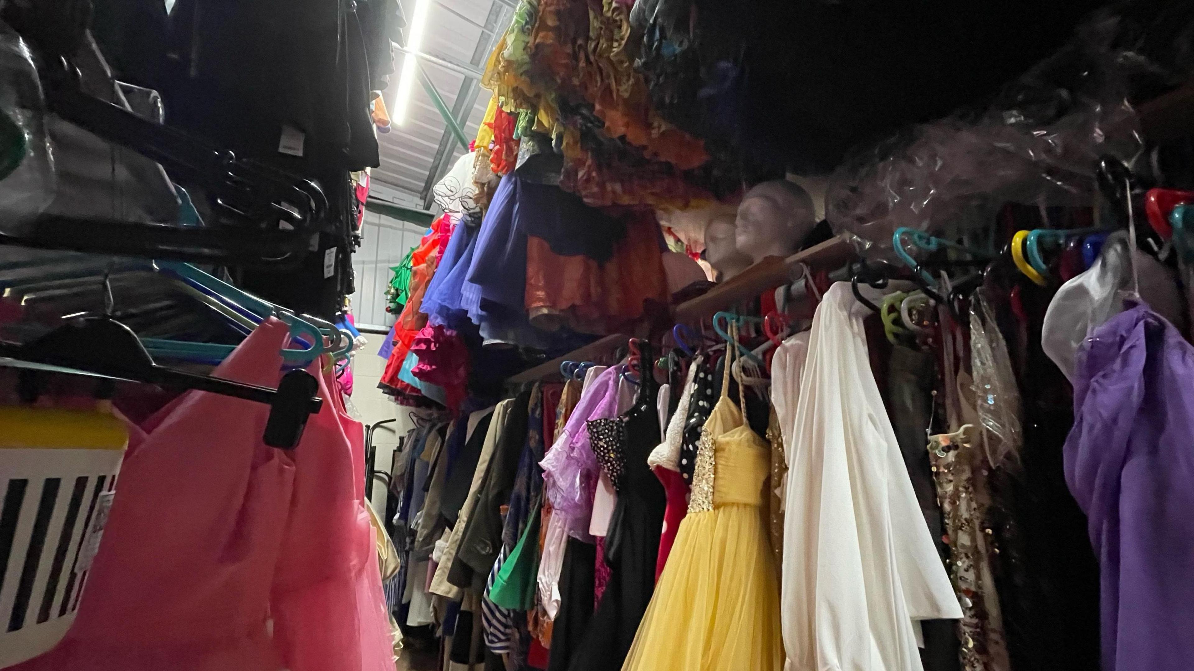 Racks of costumes on coat hangers.