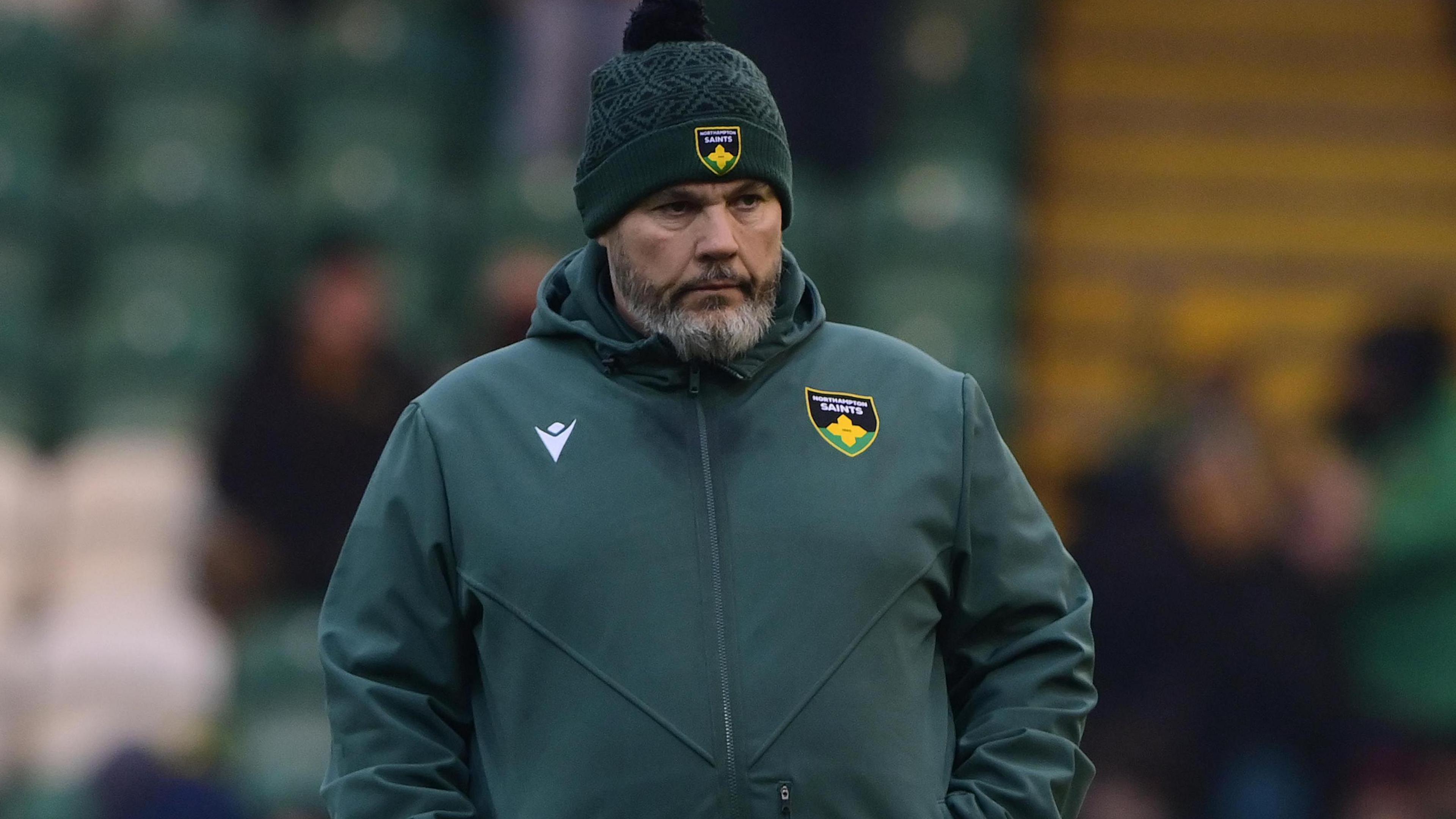 Matt Ferguson, wearing a green Northampton Saints branded woolly hat and hoody