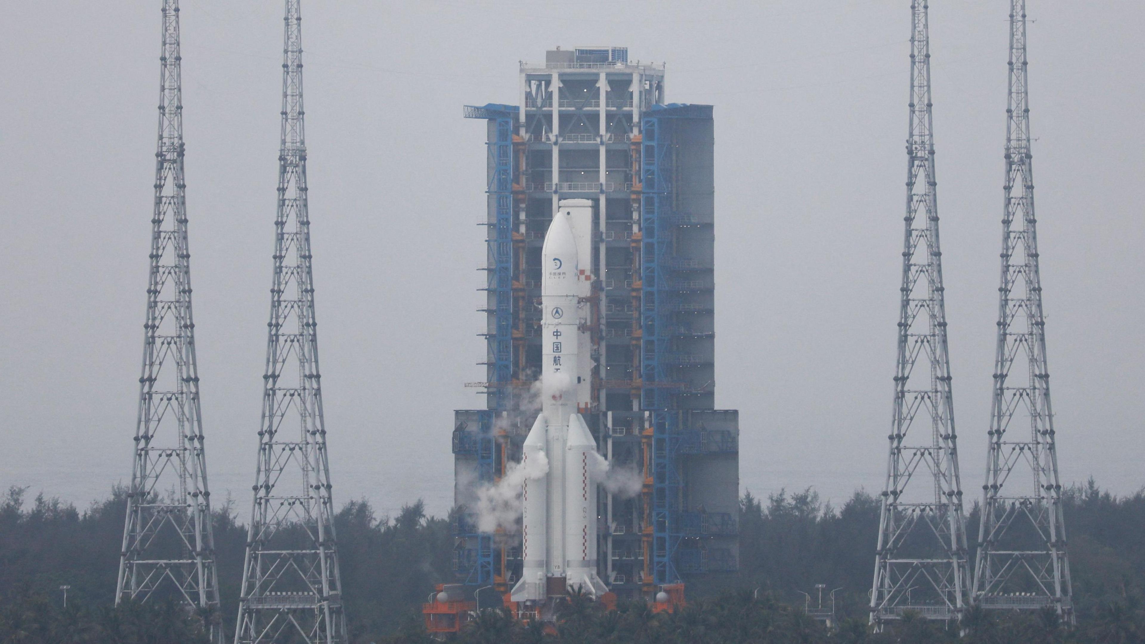 A space rocket with smoke billowing around the engines, as it gets ready for a safe launch