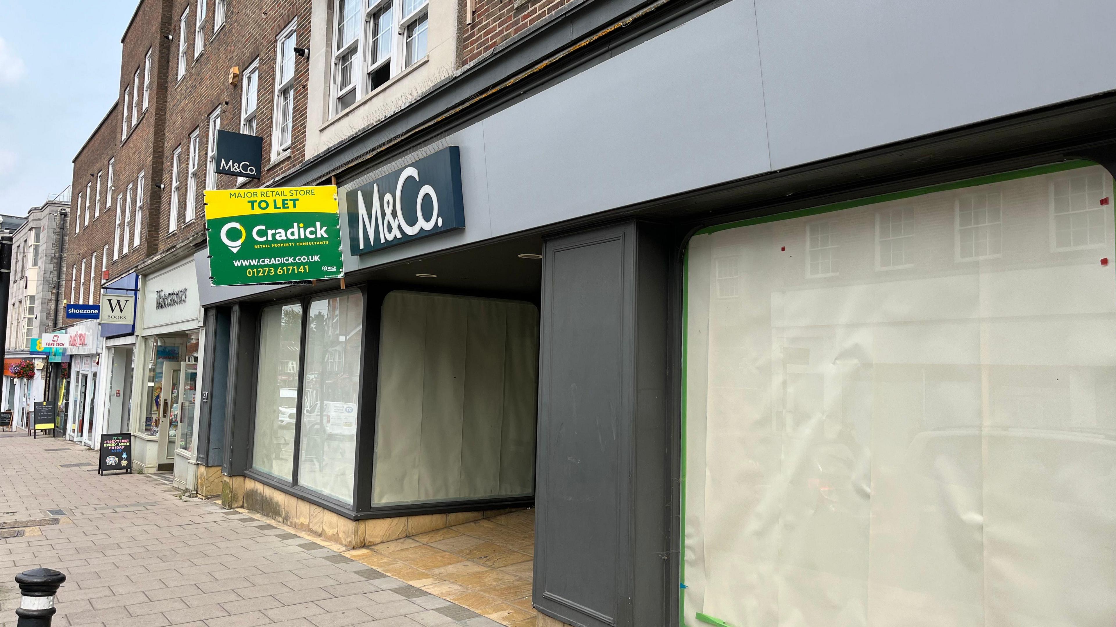 An empty store front where M&Co used to be in East Grinstead. It has a sign saying "to let" on the front