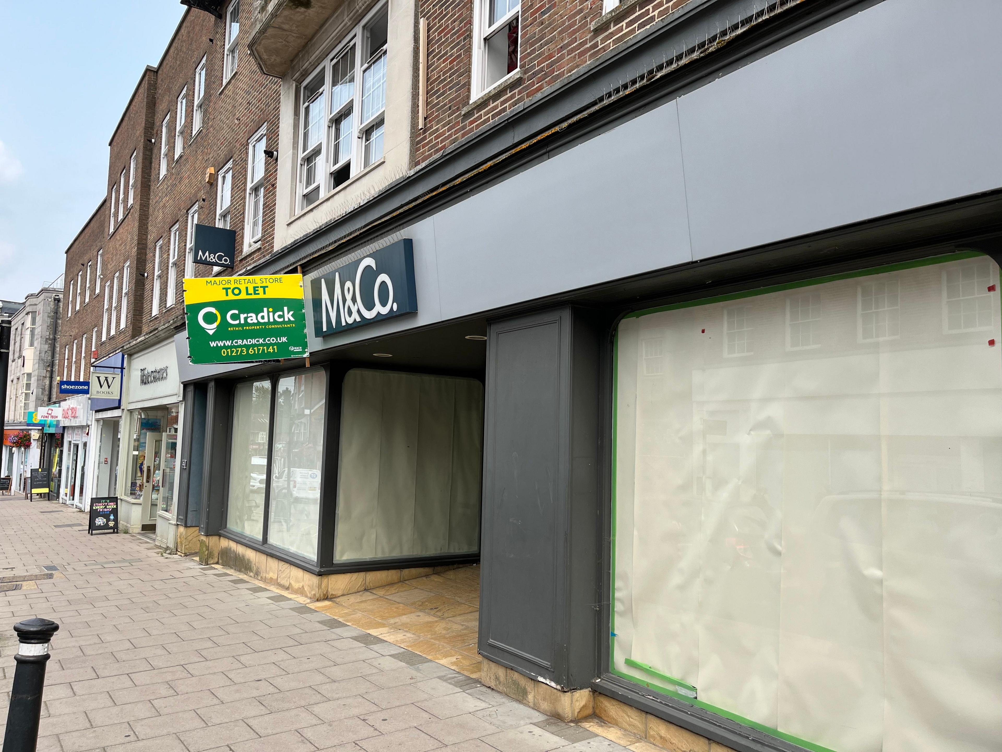 An empty store front where M&Co used to be in East Grinstead. It has a sign saying "to let" on the front