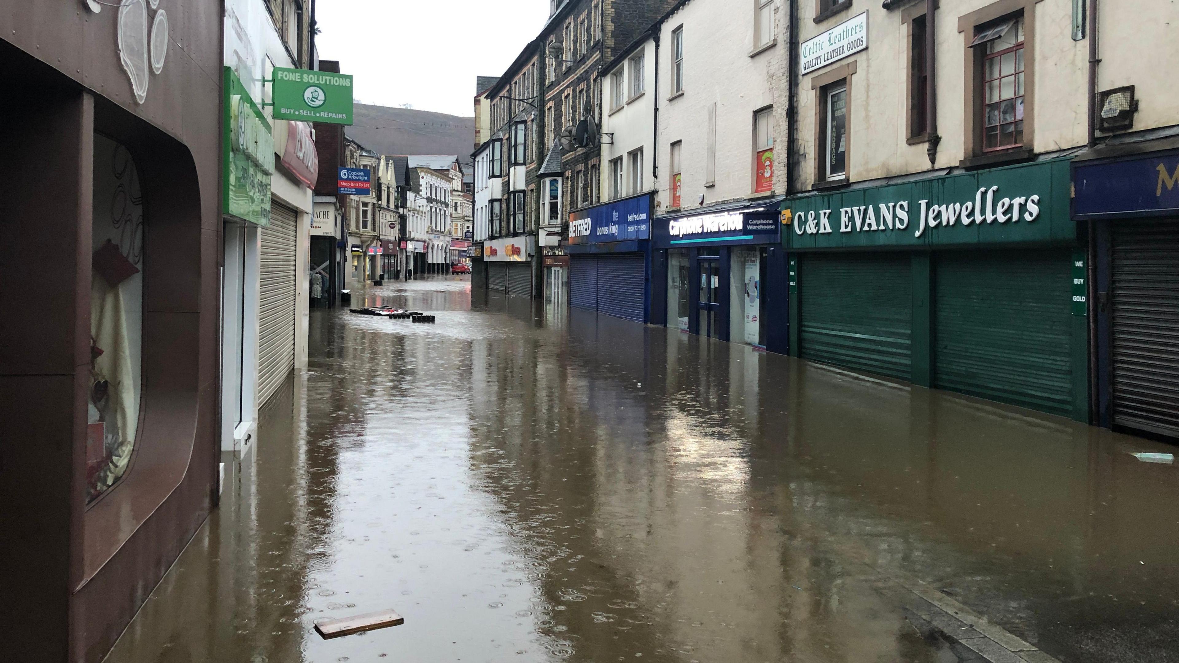 Pontypridd's Taff Street during flooding, with water covering the entire street