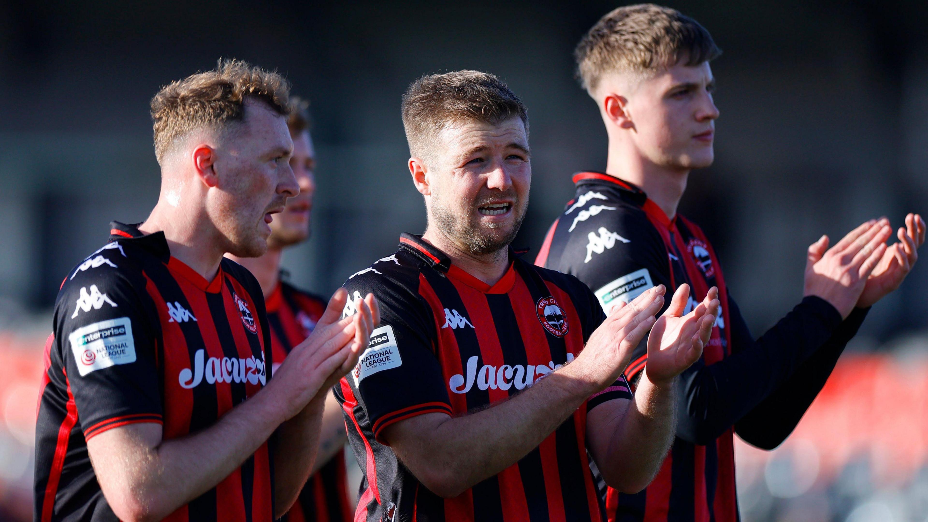 Truro City platers applaud their fans