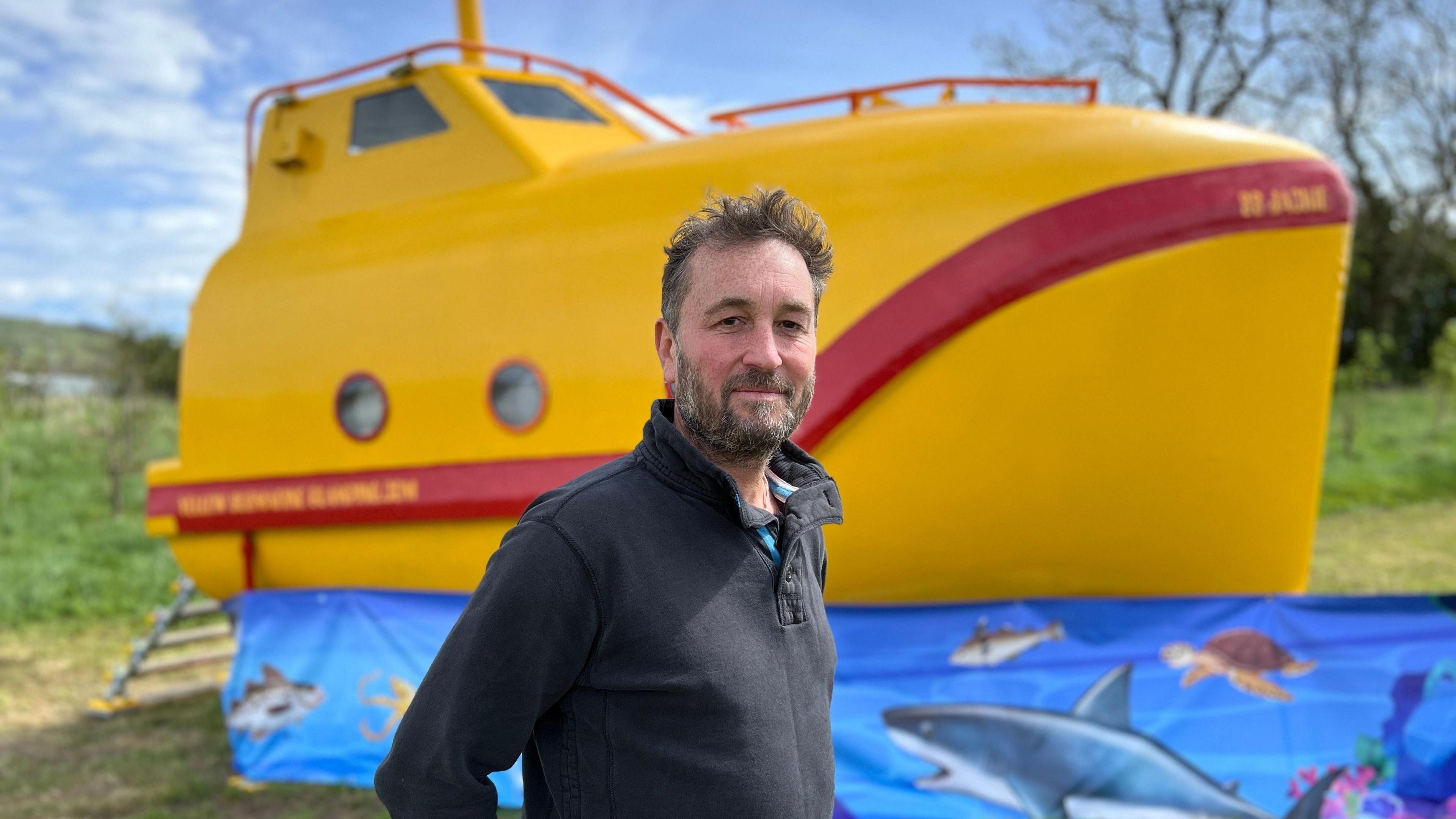 Mr Barton in front of the boat