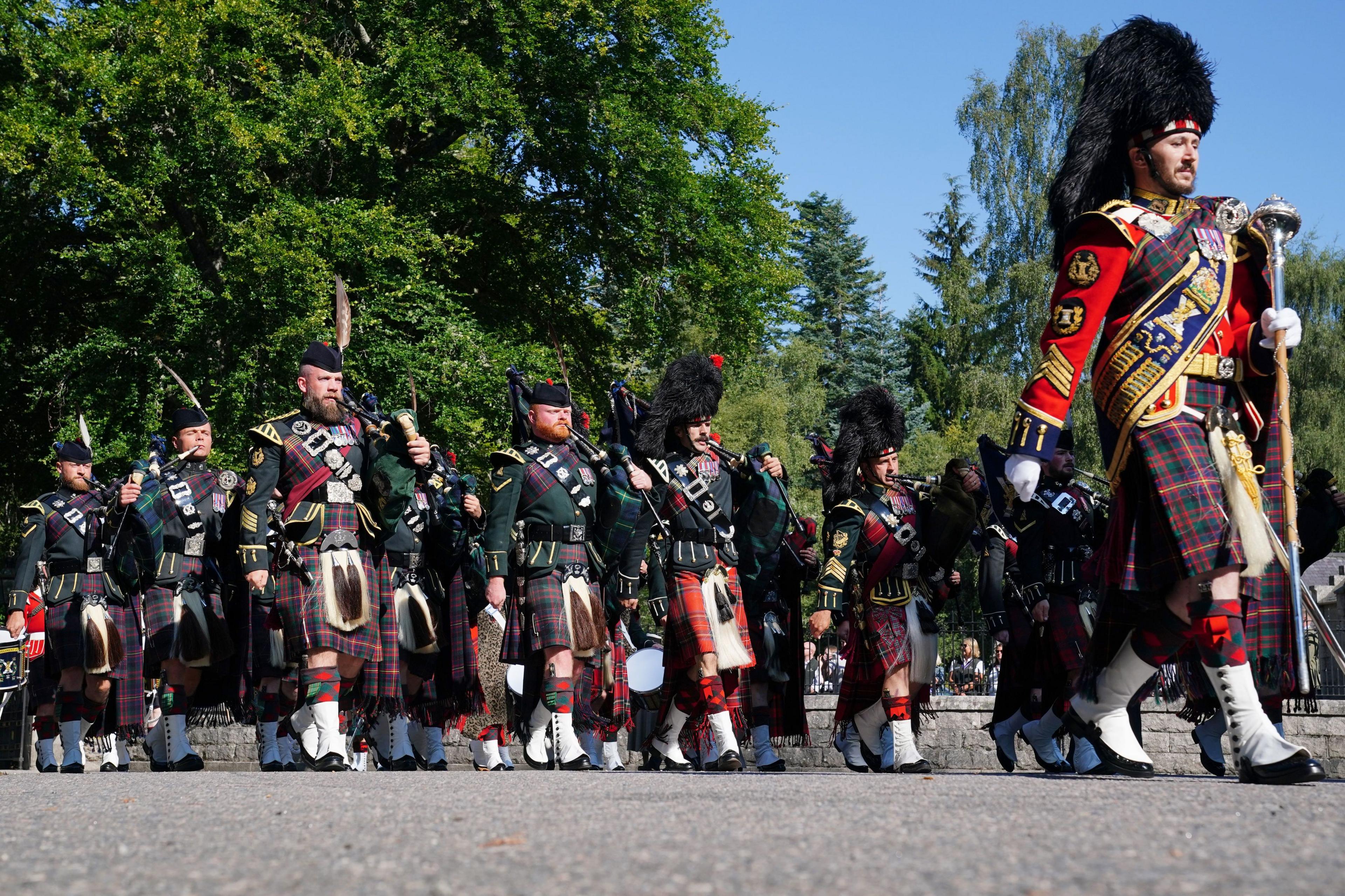 The pipe band of 3 & 4 SCOTS, Royal Regiment of Scotland as King Charles III carries out an inspection of the Balaklava Company, 5th Battalion, The Royal Regiment of Scotland, at the gates of Balmoral, as he takes up summer residence at the castle.