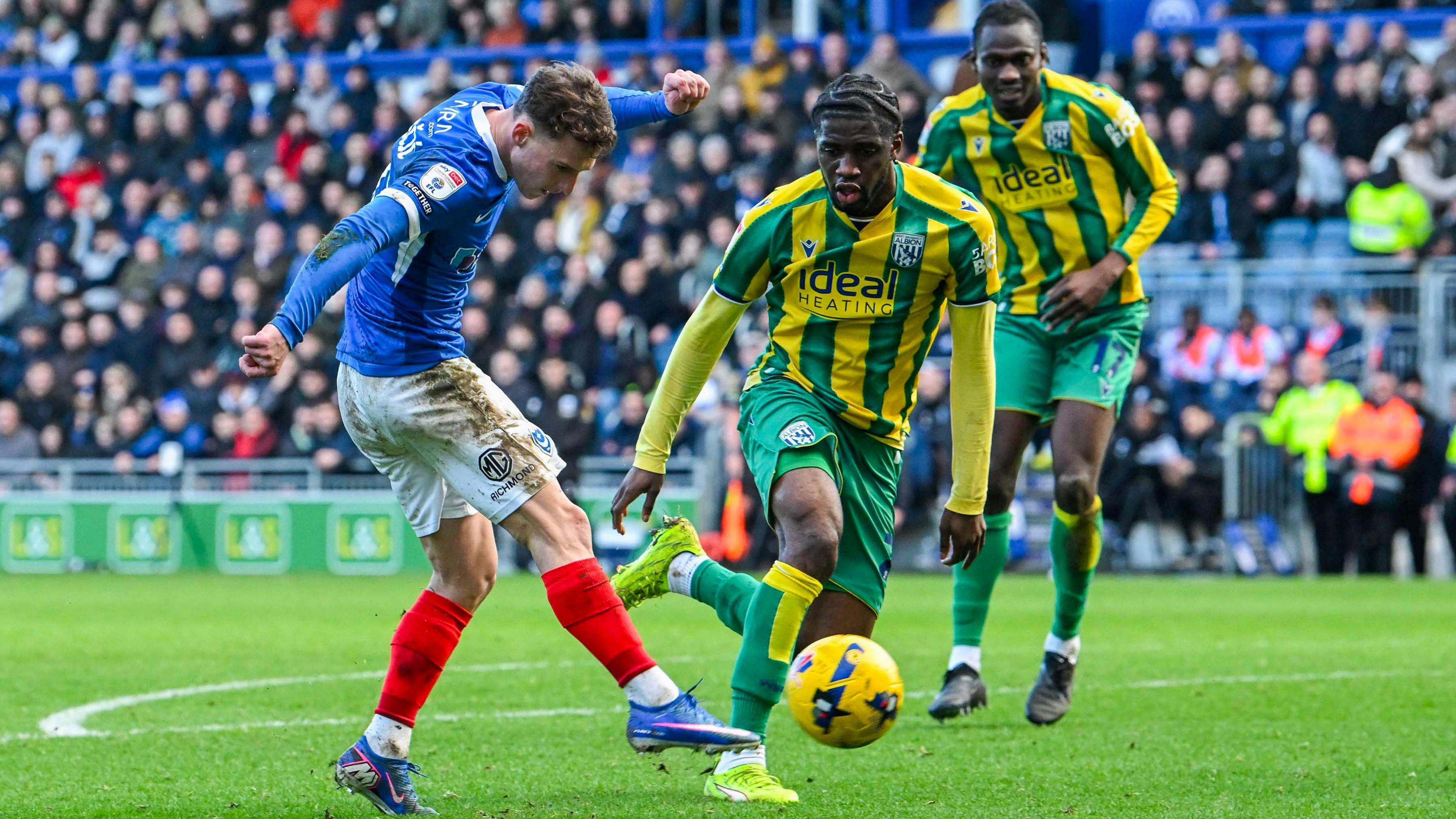 Portsmouth player Adrian Segecic (left) shoots as two West Brom defenders look on