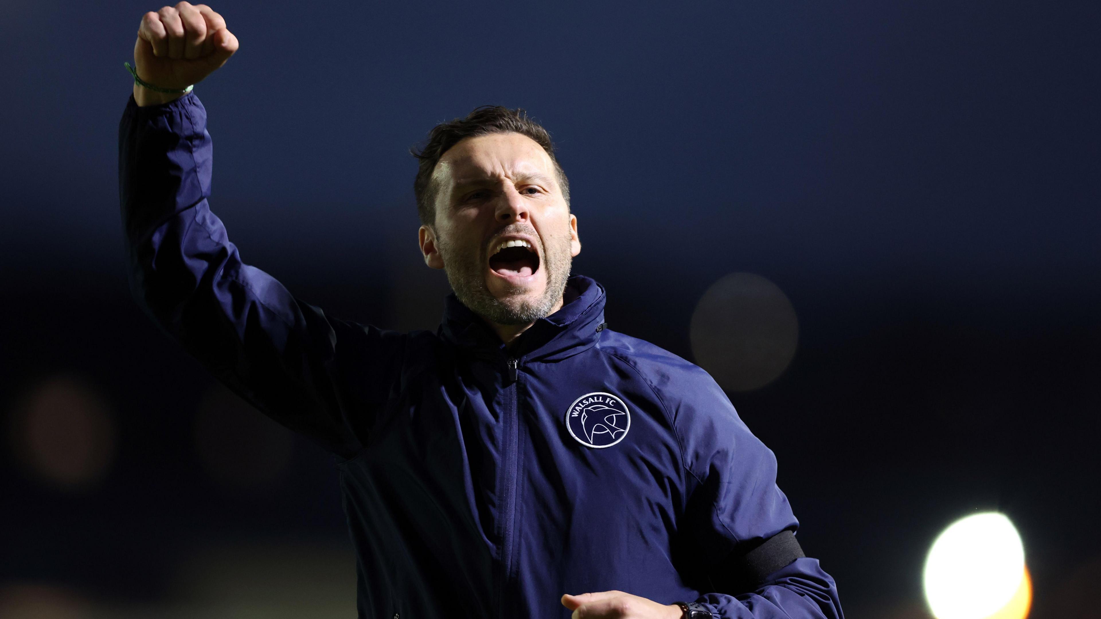 Walsall manager Mat Sadler celebrates at full-time after winning 4-2 at Newport County