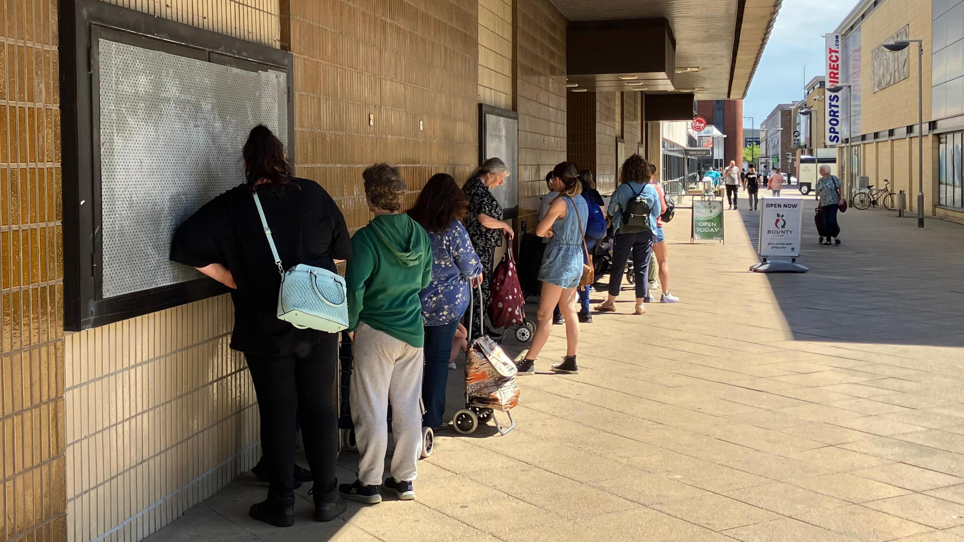 A queue of people outside the old BHS store in Harlow which is now open as a discounted supermarket