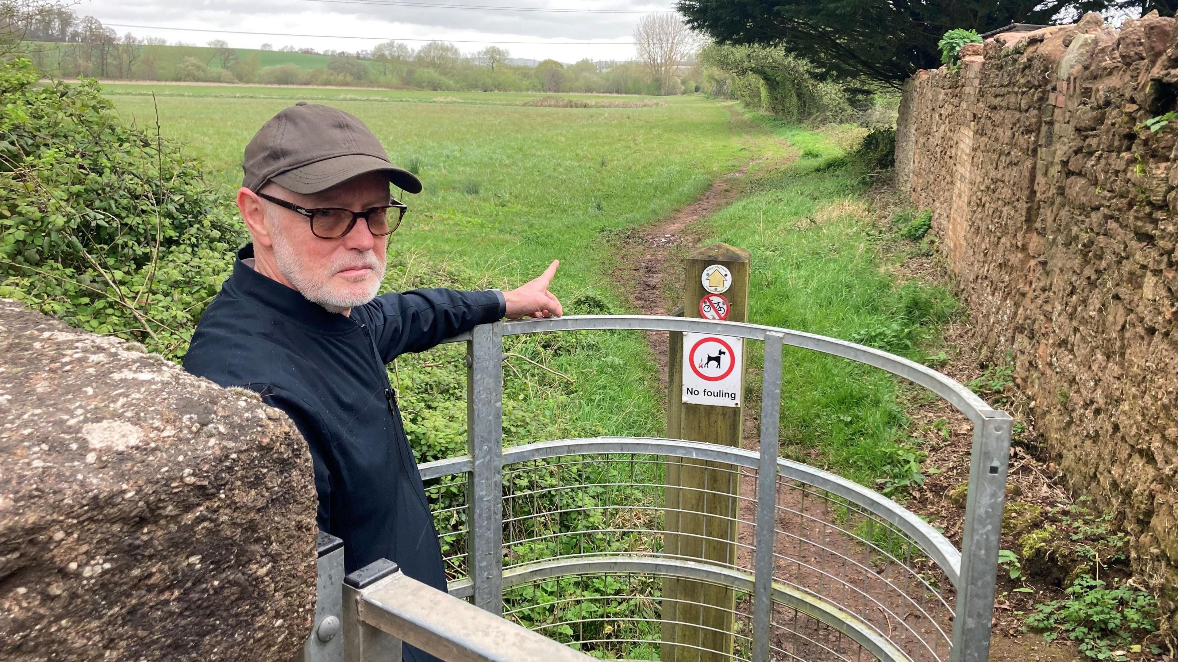 Charles Biscoe pointing towards a path