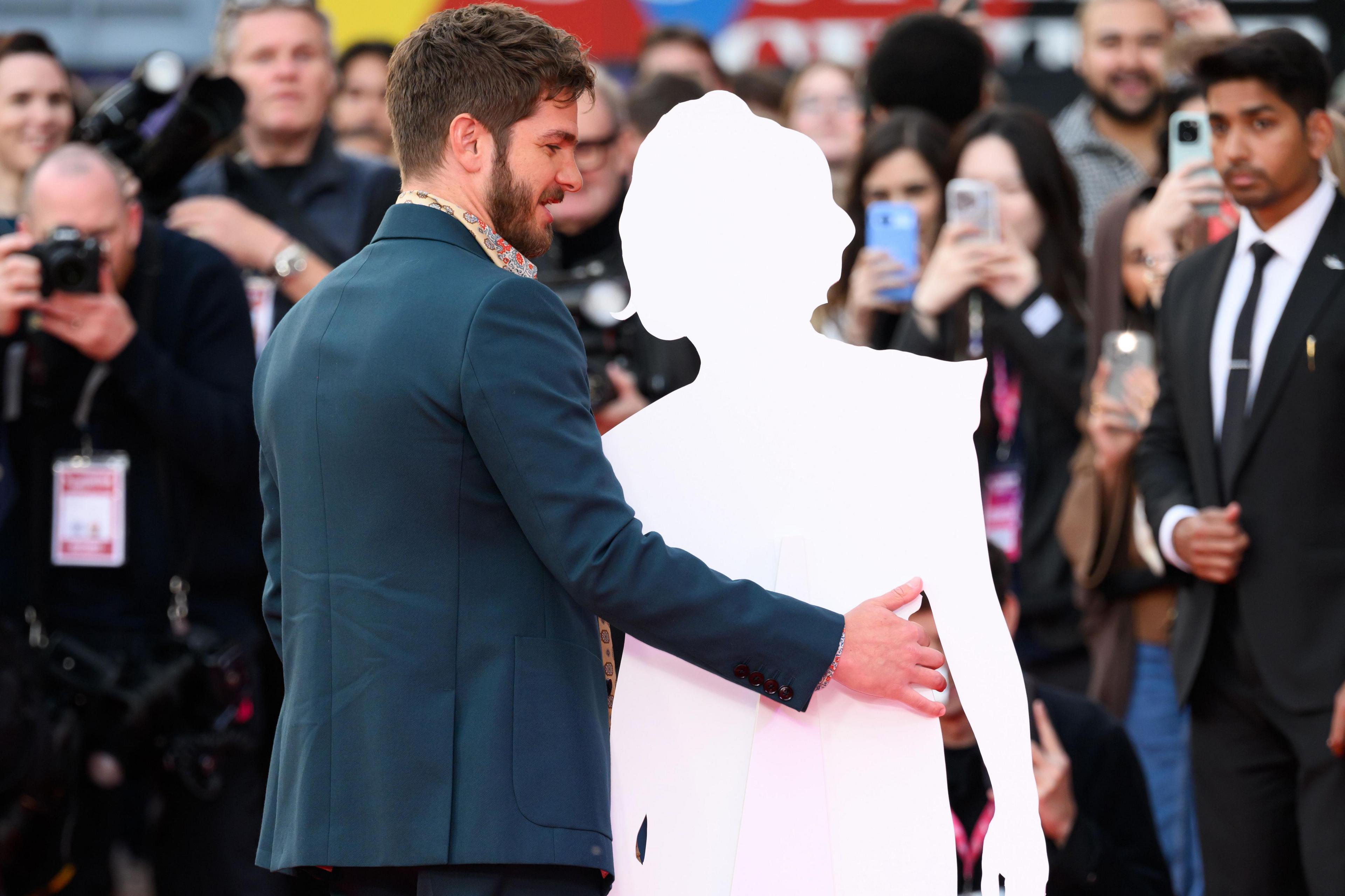 Andrew Garfield poses with a cardboard cutout of Florence Pugh during the "We Live In Time" Headline Gala during the 68th BFI London Film Festival at The Royal Festival Hall on October 17, 2024 in London, England