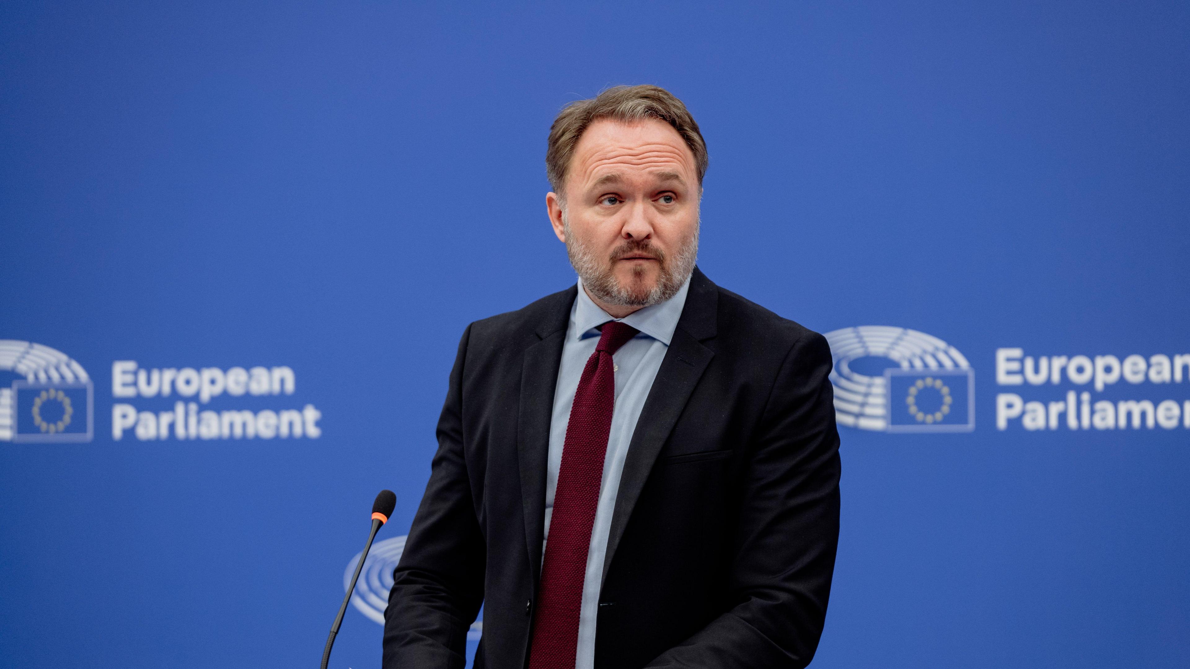 Dan Jorgensen in suit and tie against a blue background