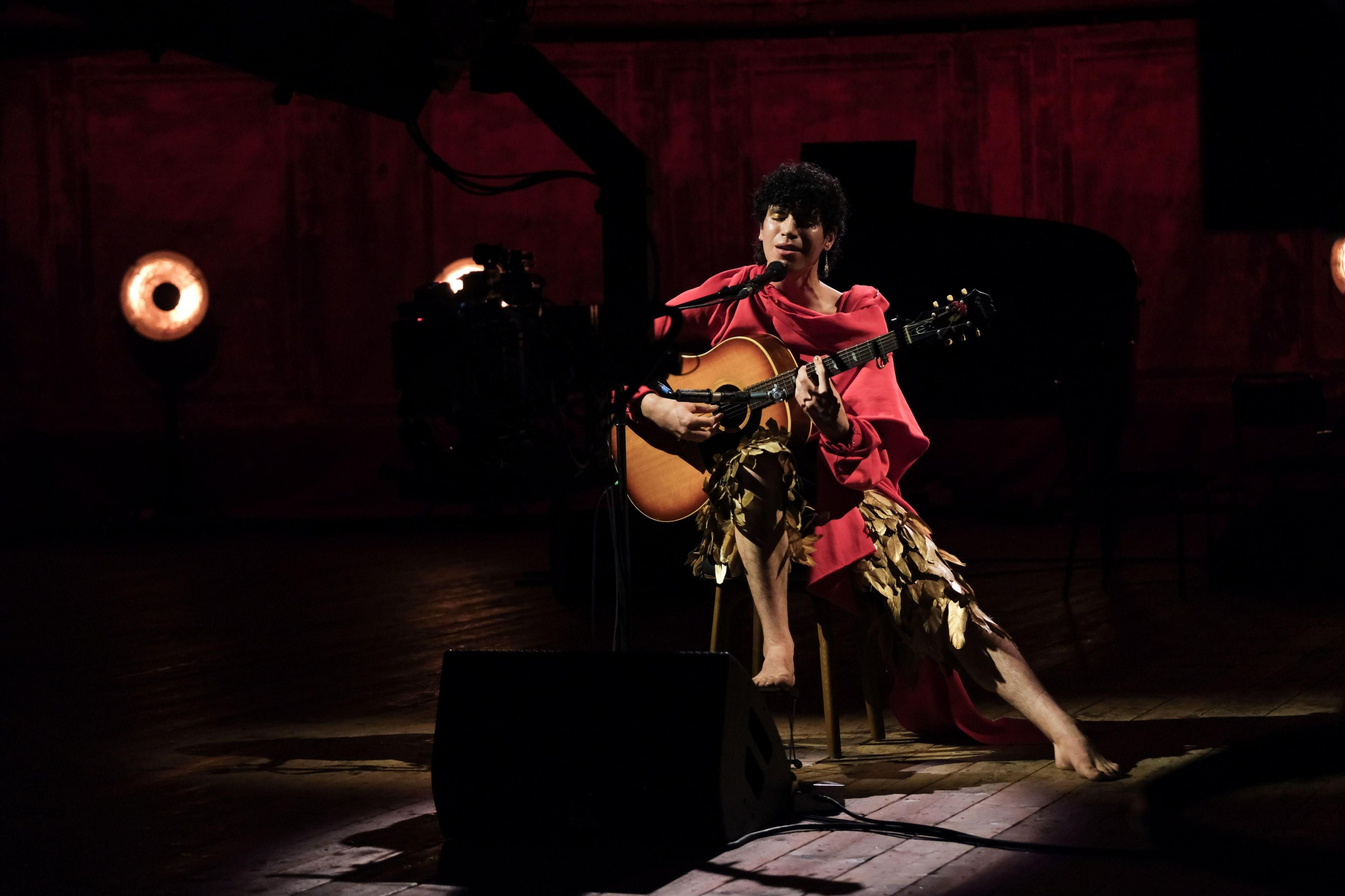 Jacob Alon closes their eyes and sings passionately into a microphone while appearing on the BBC's Later... With Jools Holland