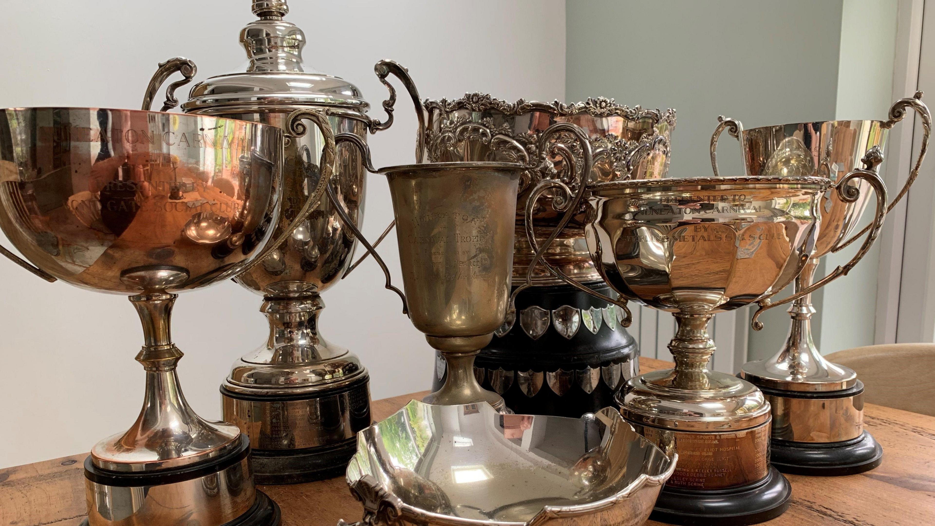 A collection of old trophies on a table.