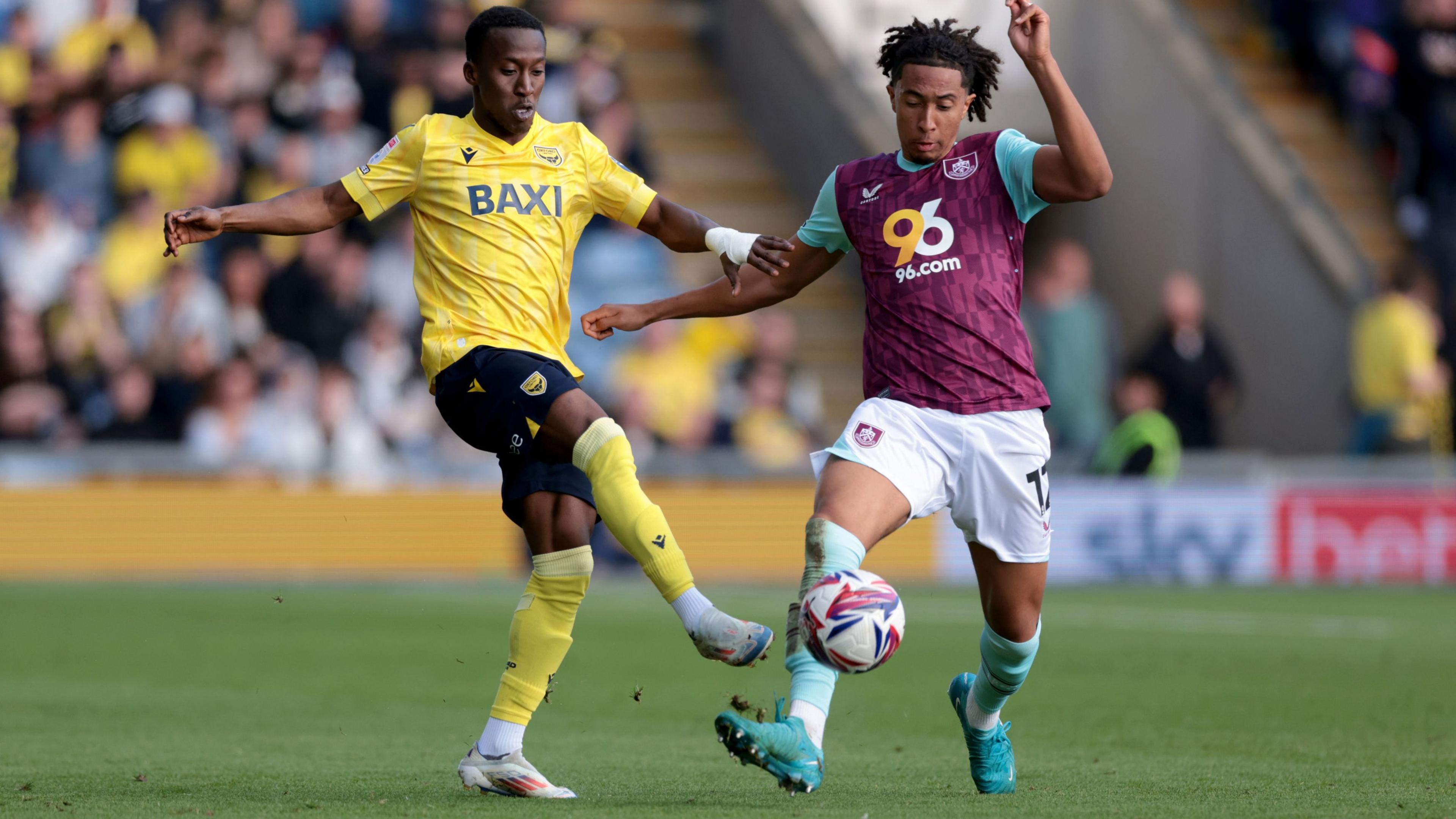 Oxford United's Siriki Dembele is challenged by Burnley's Bashir Humphreys