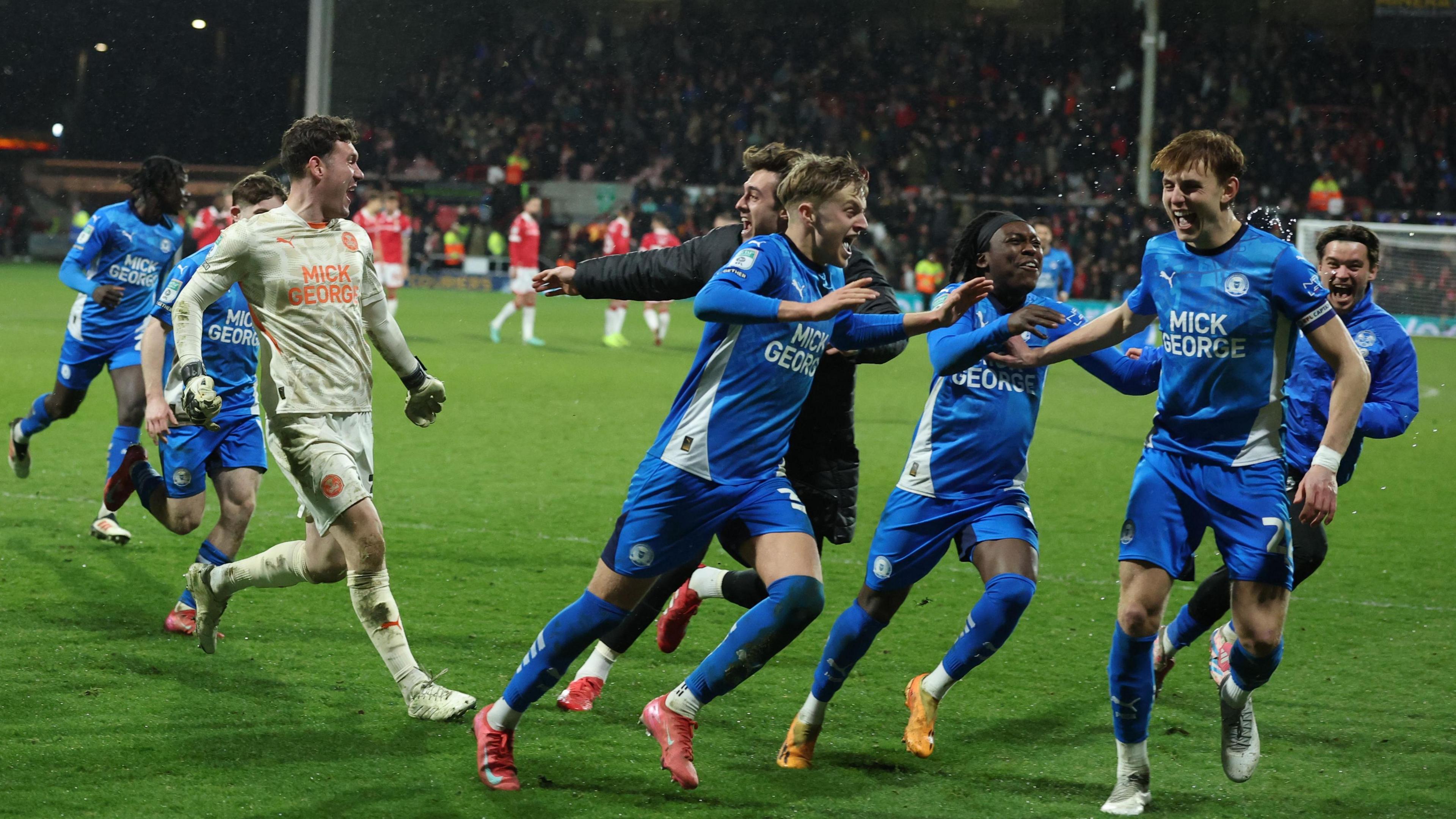 Posh keeper Jed Steer and his team-mates celebrate at the Racecourse Ground