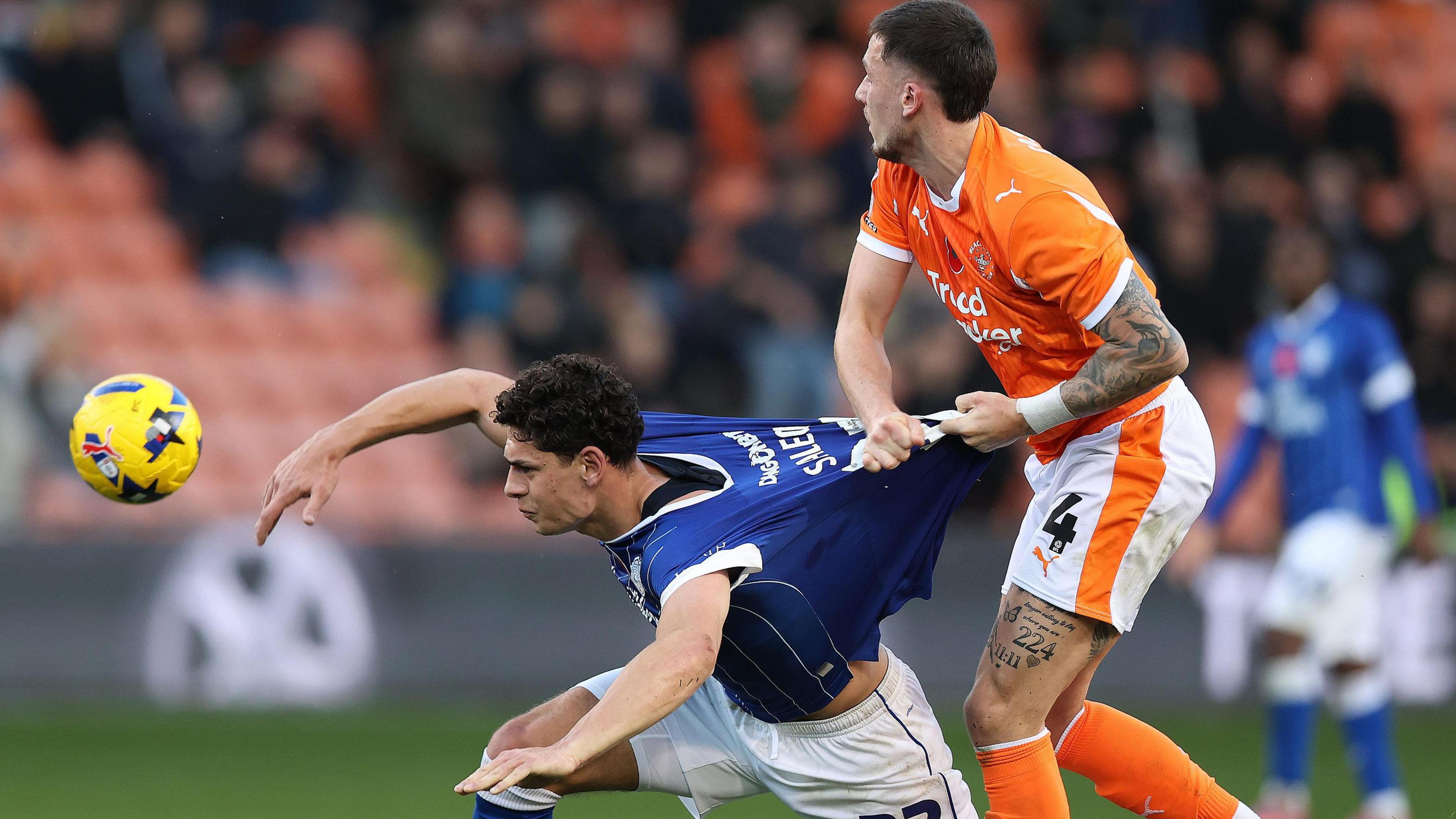 Cardiff City's Yousef Saleh battles for the ball with Blackpool's Oliver Casey