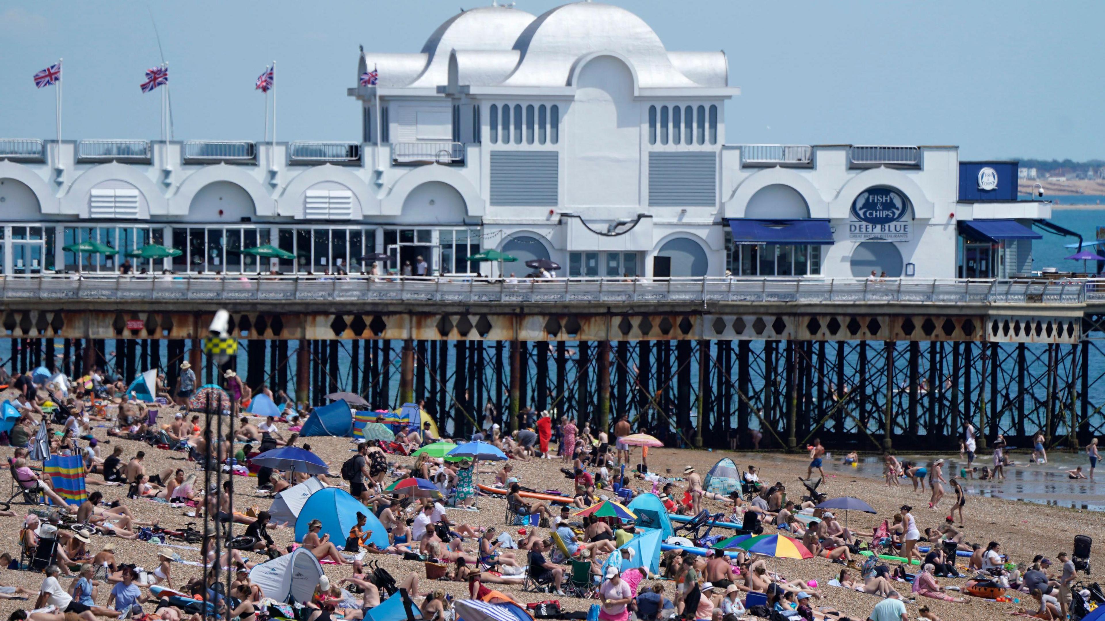 People enjoy the warm weather on Southsea beach in Hampshire.