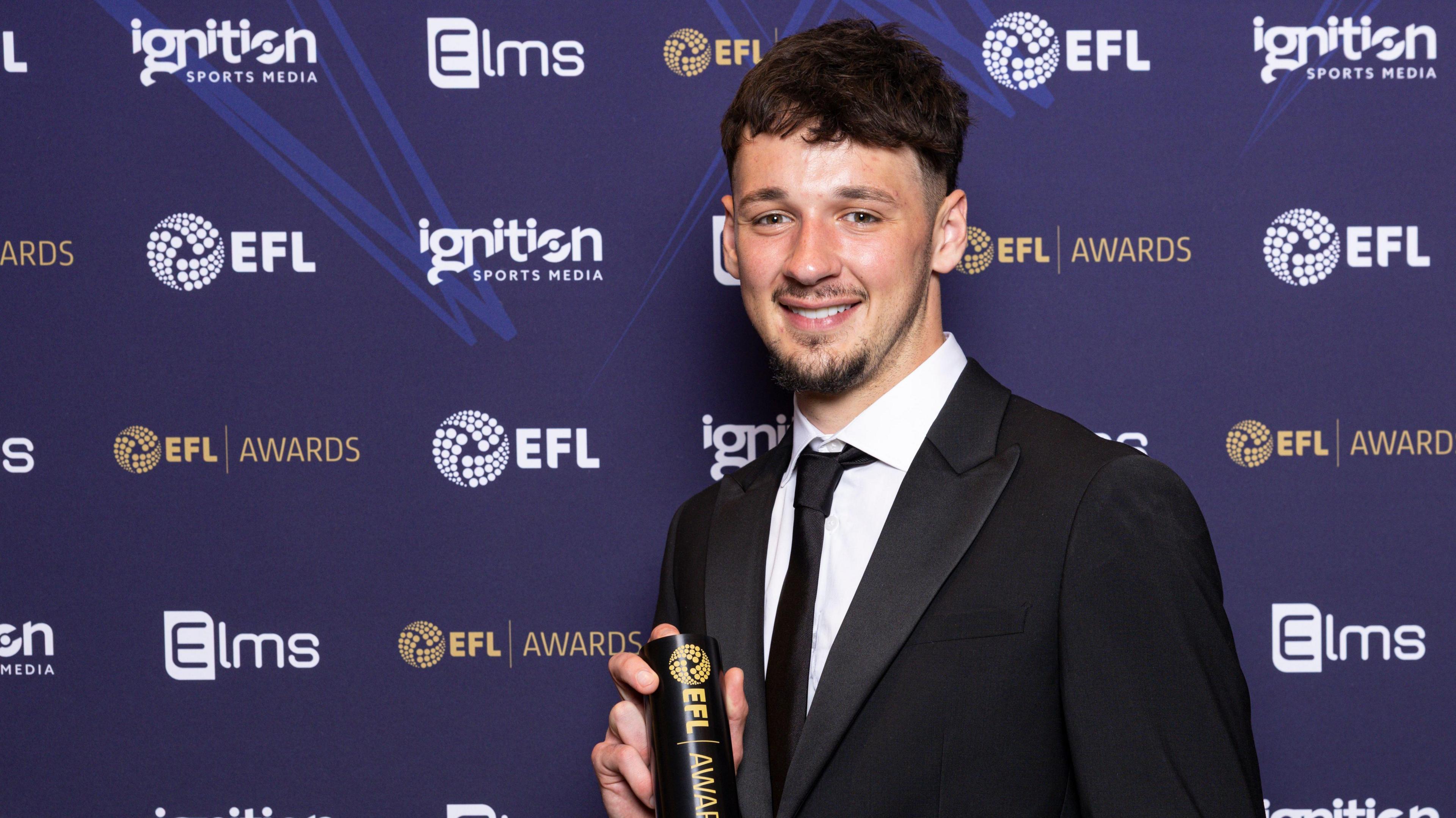 Burnley goalkeeper James Trafford holds his EFL award