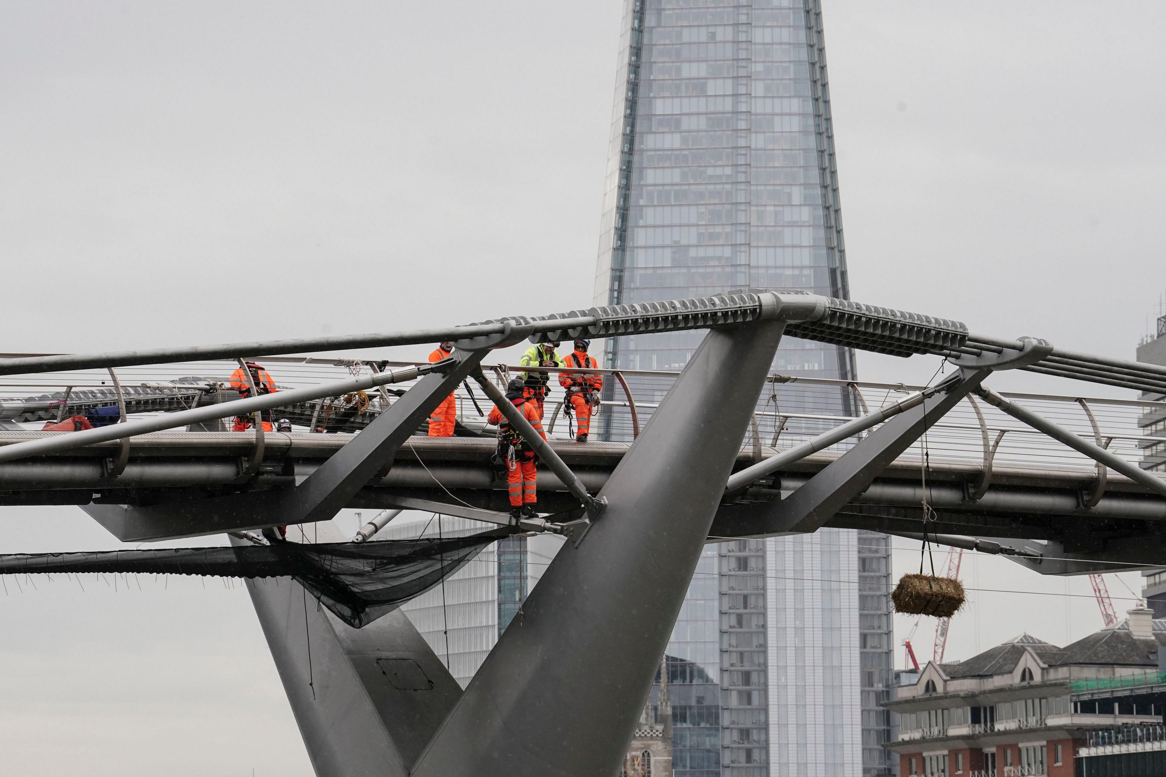 Straw bale hangs from bridge 