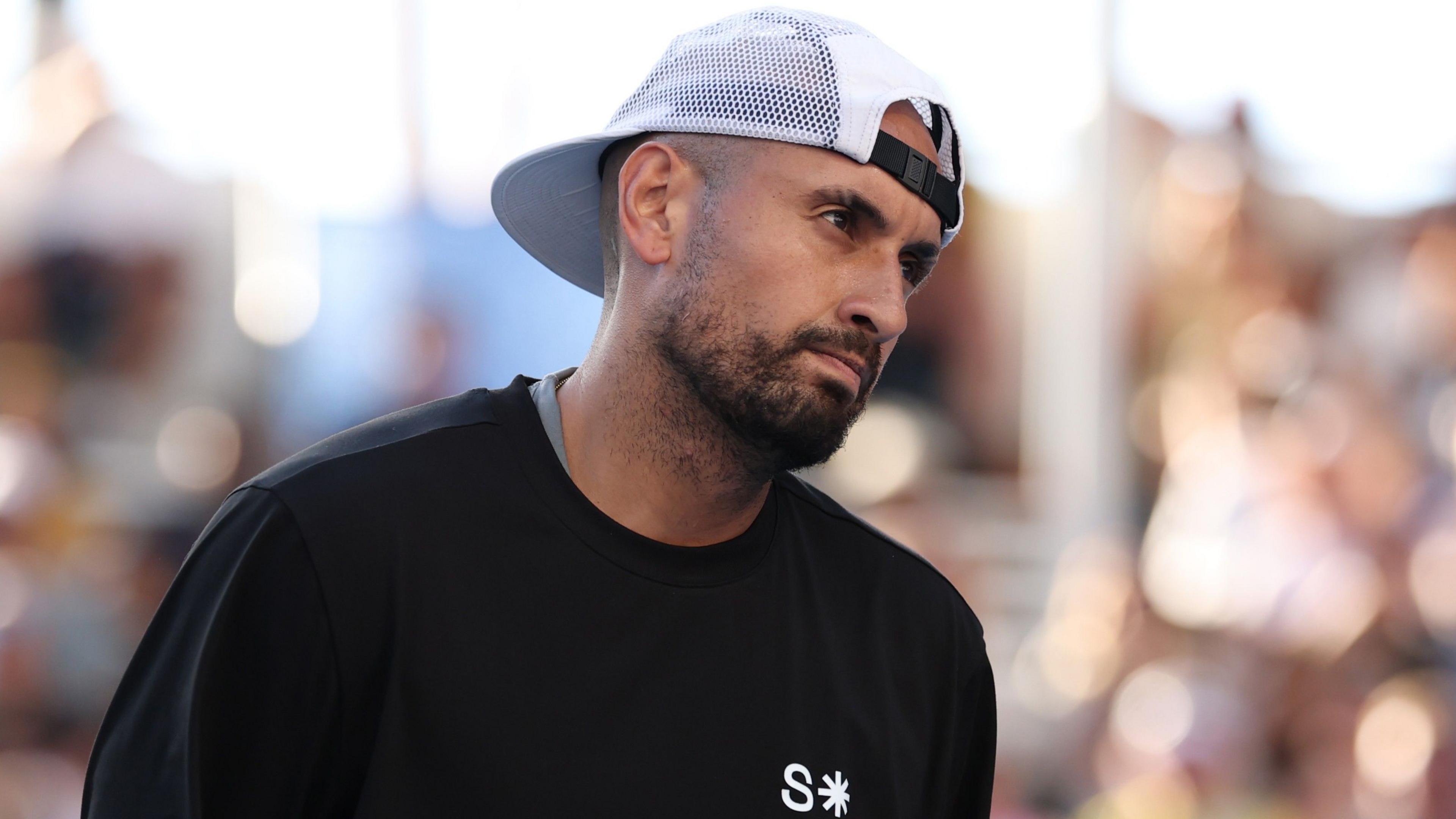 Nick Kyrgios watches on during January's Australian Open