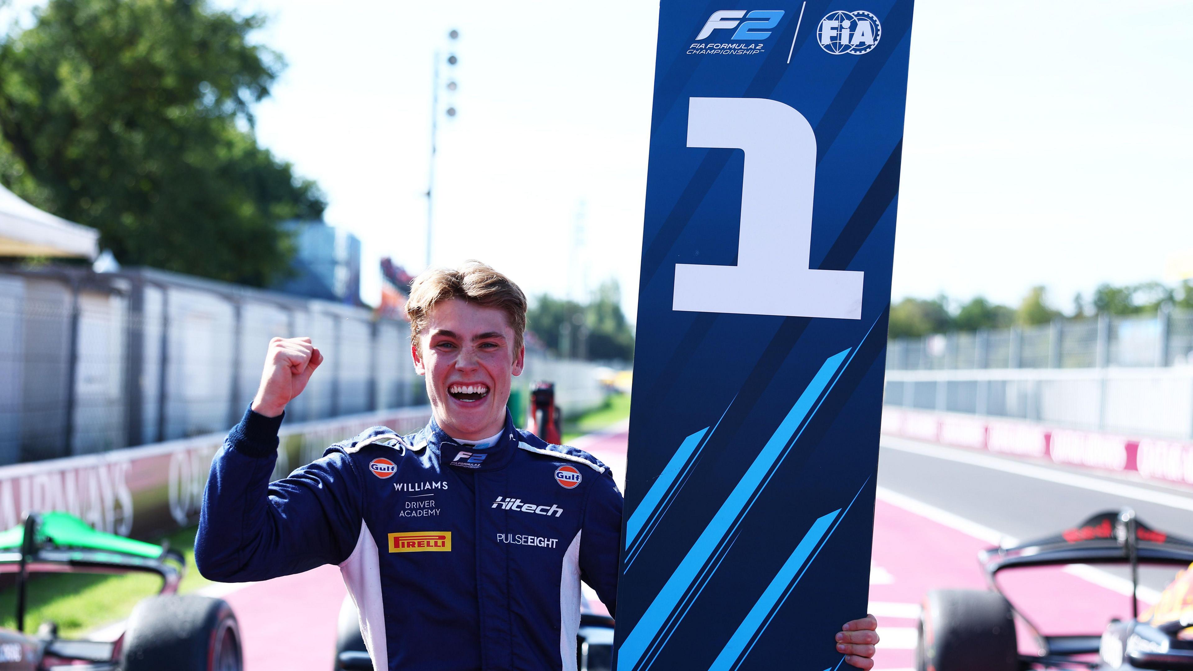 Race winner Luke Browning celebrates in parc ferme during the Round 11 Monza Feature race of the Formula 2 Championship at Autodromo Nazionale Monza on 7 September Monza, Italy.  He is cheering while punching the air and holding the number one board. 