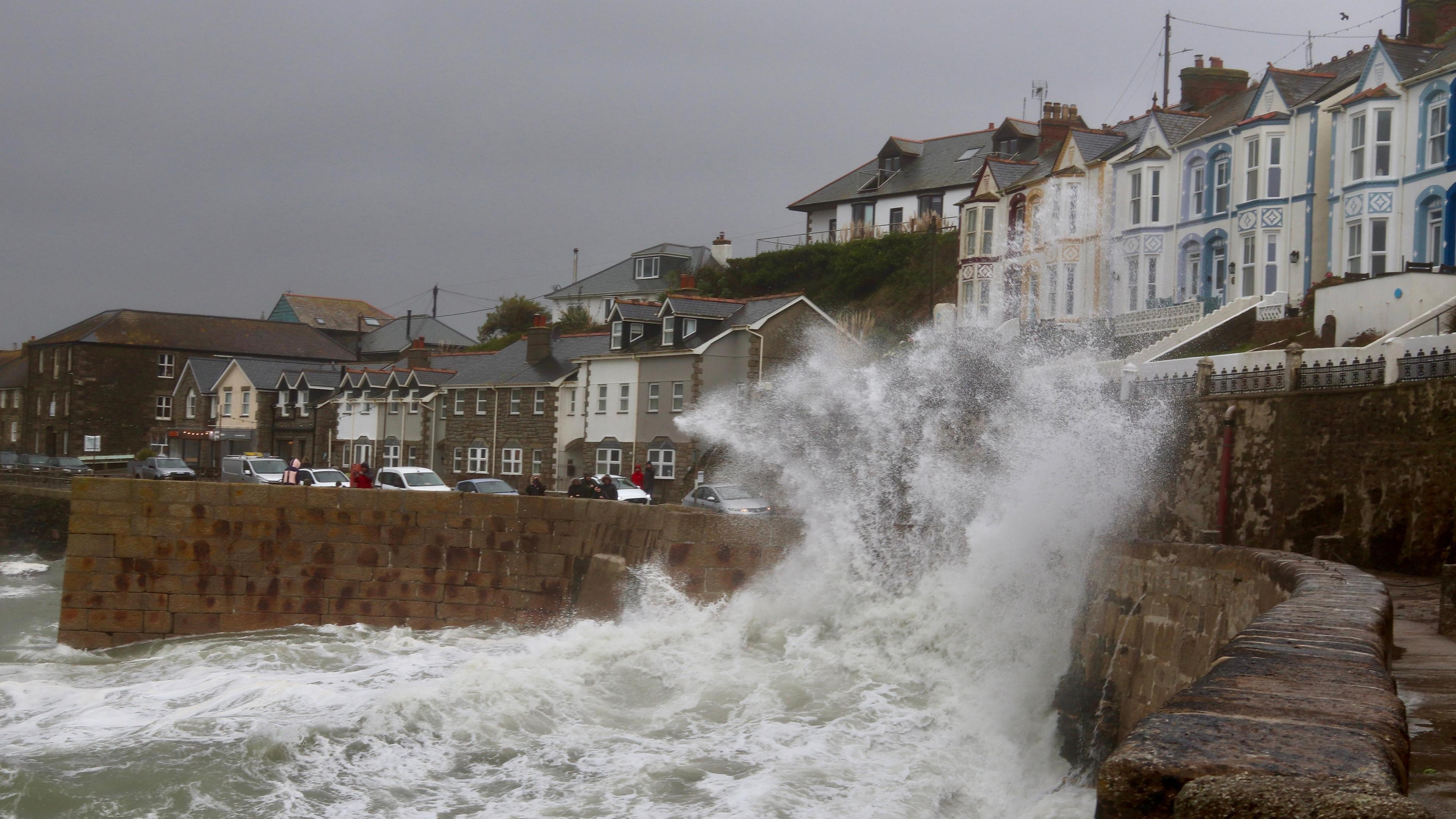 A wave crashes into a break wall in Cornwall