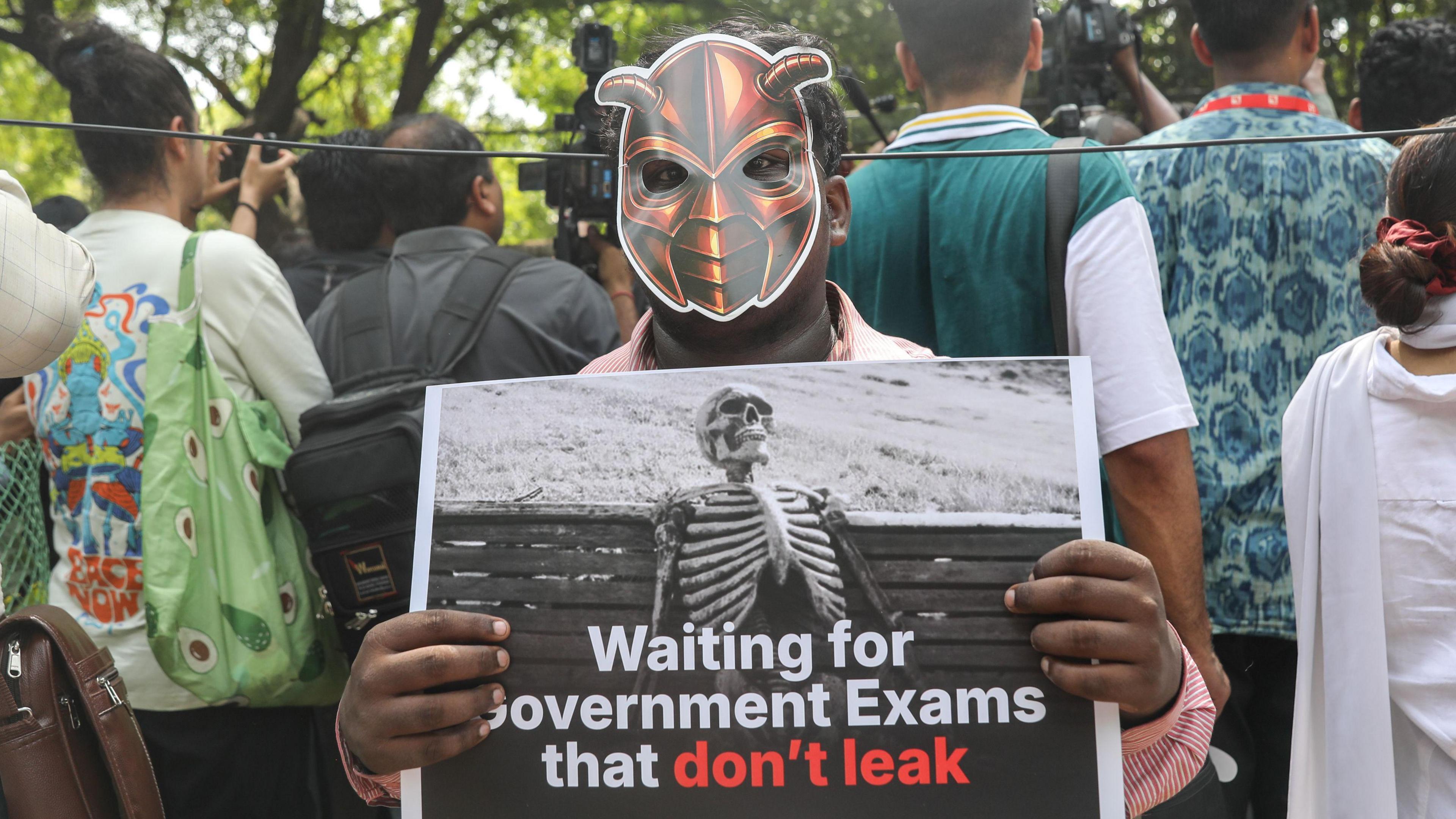 A supporter of the satirical youth movement Cockroach Janta Party (CJP) holds a placard as people participate in a protest organized by CJP founder Abhijeet Dipke in New Delhi, India, 06 June 2026. 