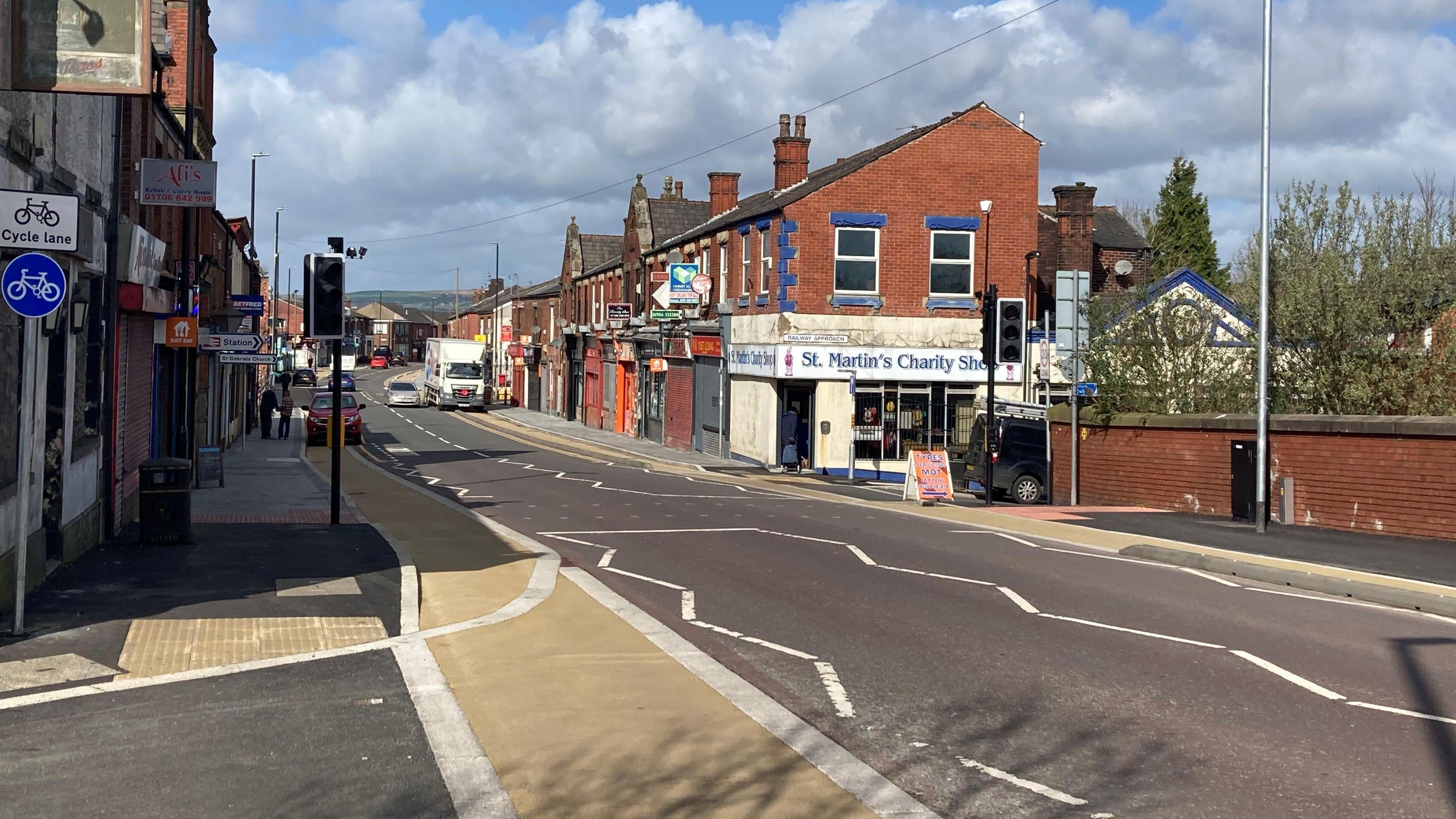 The Castleton cycle lane runs alongside a main road through the town high street